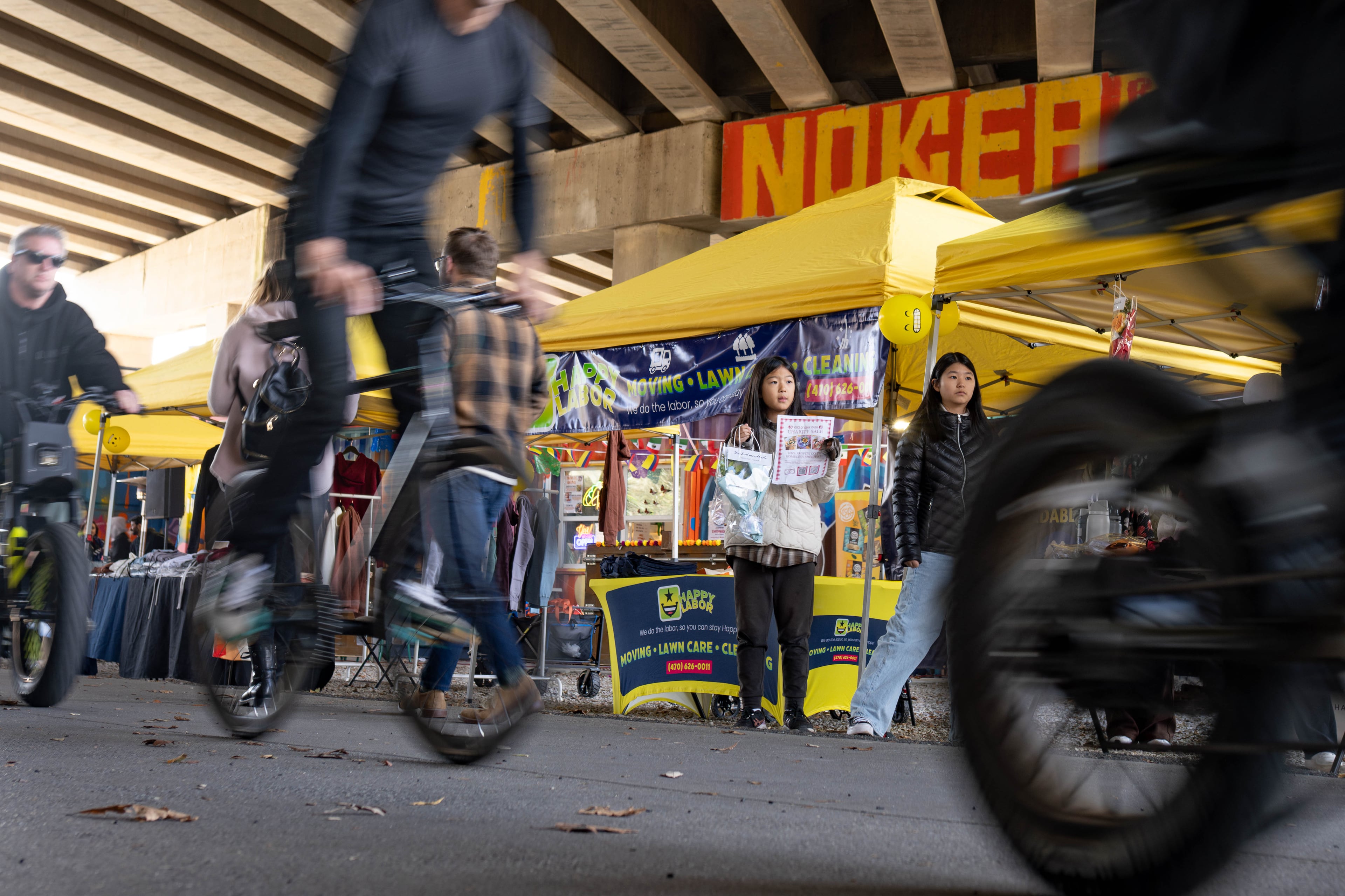 Two children advertise a youth charity at the Atlanta Beltline Marketplace's annual Small Business Saturday event Saturday, Nov. 29, 2025. (Ben Hendren for the AJC)