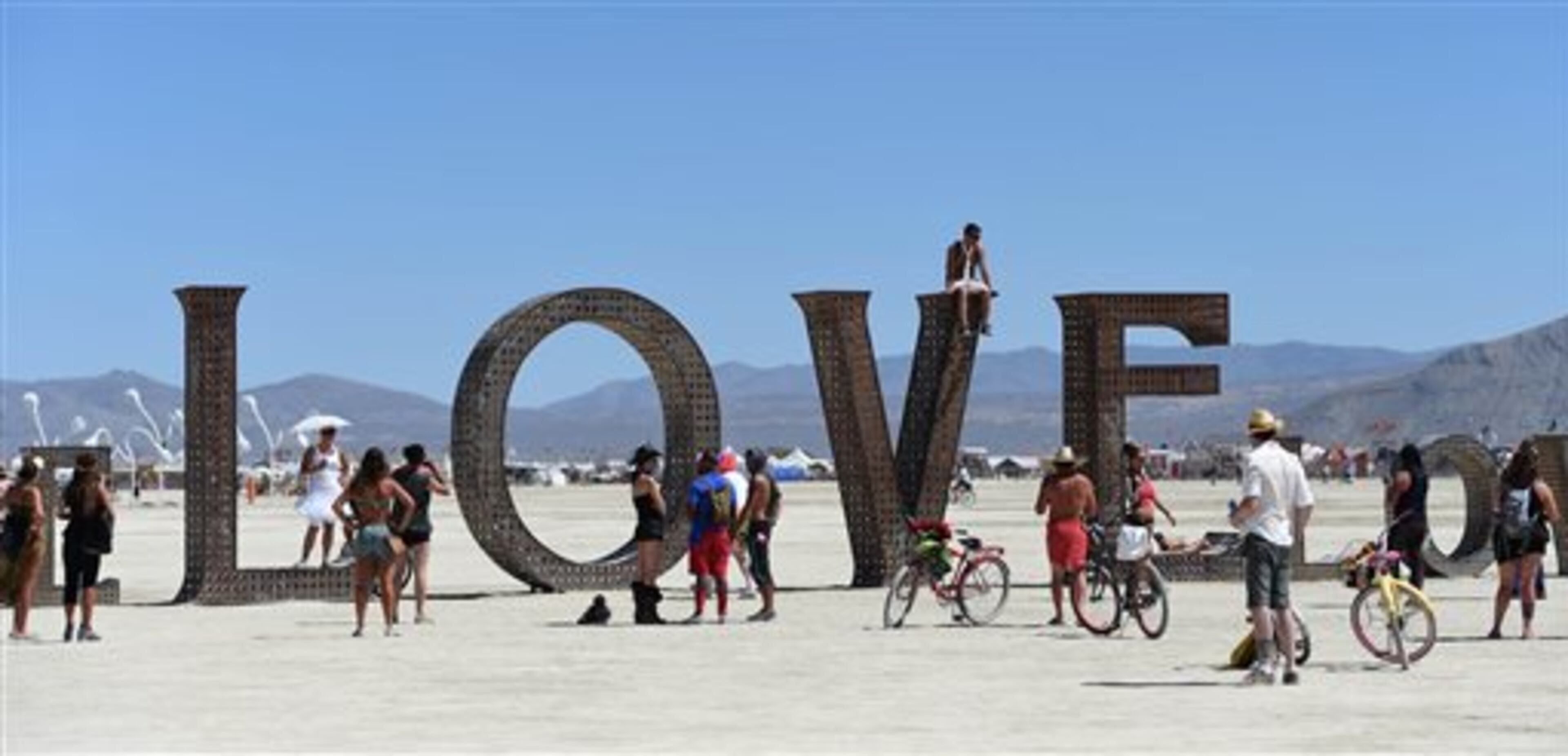 In this Aug. 27, 2014 photo, participants walk around at the Burning Man festival on the Black Rock Desert of Gerlach, Nev. Organizers call Burning Man the largest outdoor arts festival in North America, with its drum circles, decorated art cars, guerrilla theatrics and colorful theme camps. (AP Photo/The Reno Gazette-Journal, Andy Barron)