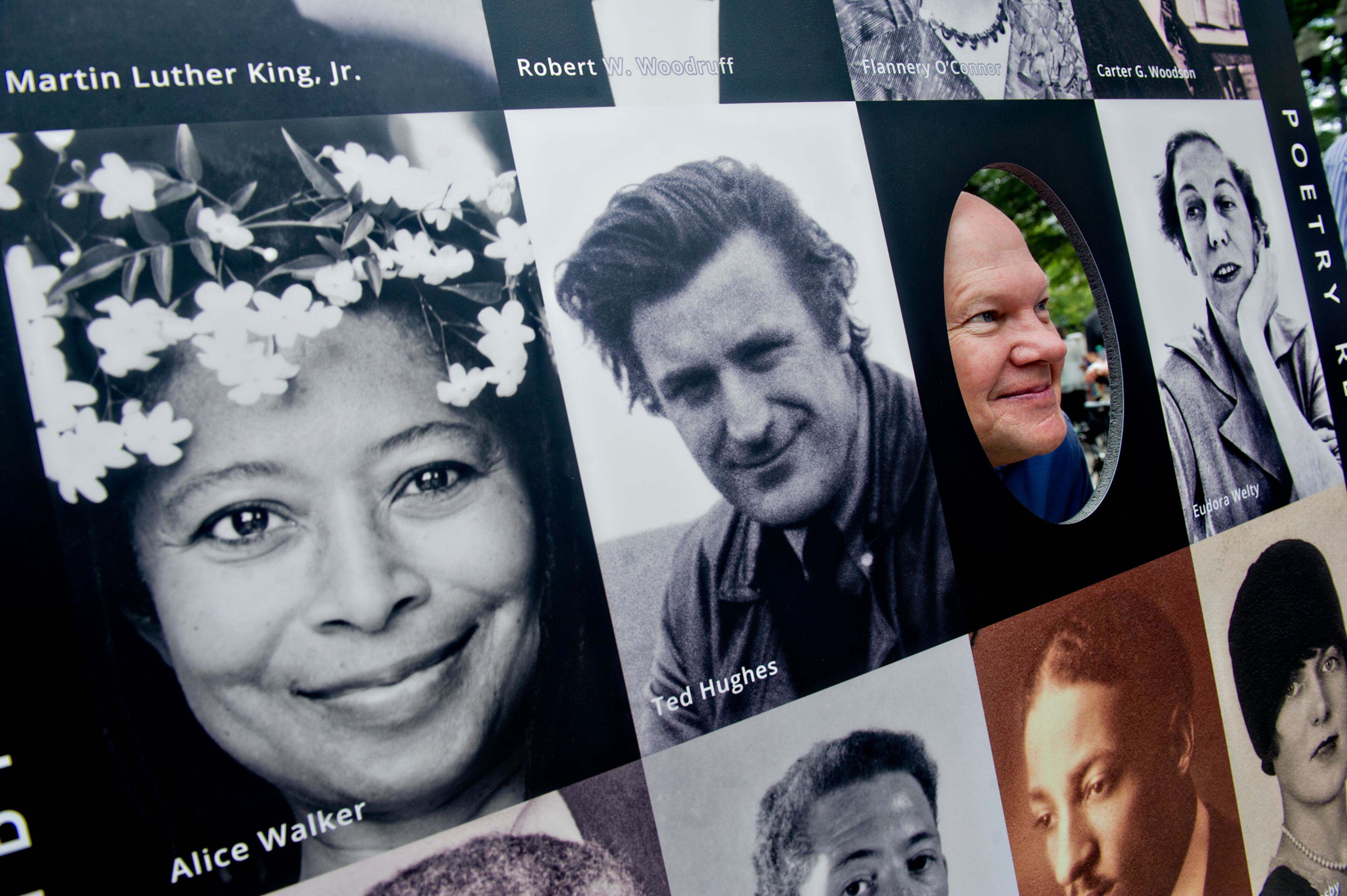 David Darracott sticks his face through a wall of portraits during the AJC Decatur Book Festival on Saturday, August 30, 2014. The ninth annual event saw tens of thousands of people come out to the downtown Decatur area to meet with world-class authors, illustrators, editors, publishers, booksellers, and artists for a weekend filled with literature, music, food, art, and fun.