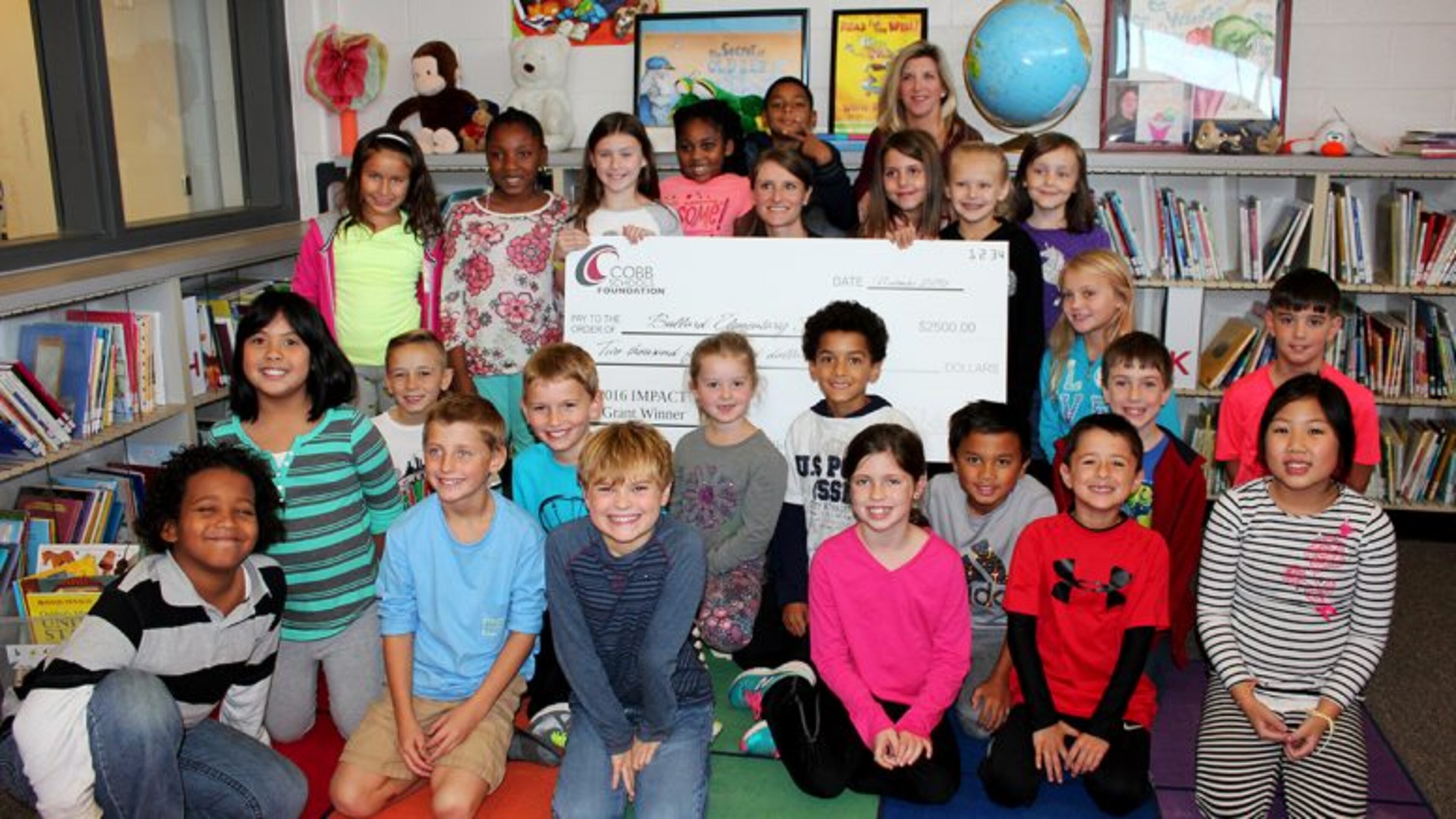 Almost $31,000 for 19 grants have been awarded to Cobb public school teachers by the Atlanta Braves Foundation and the Cobb Schools Foundation. Bullard Elementary third grade teacher Ginny Coalson poses with her students after the Cobb Schools Foundation awarded her a $2,500 IMPACT grant along with second grade teacher Shery Dishman. Courtesy of Cobb County School District