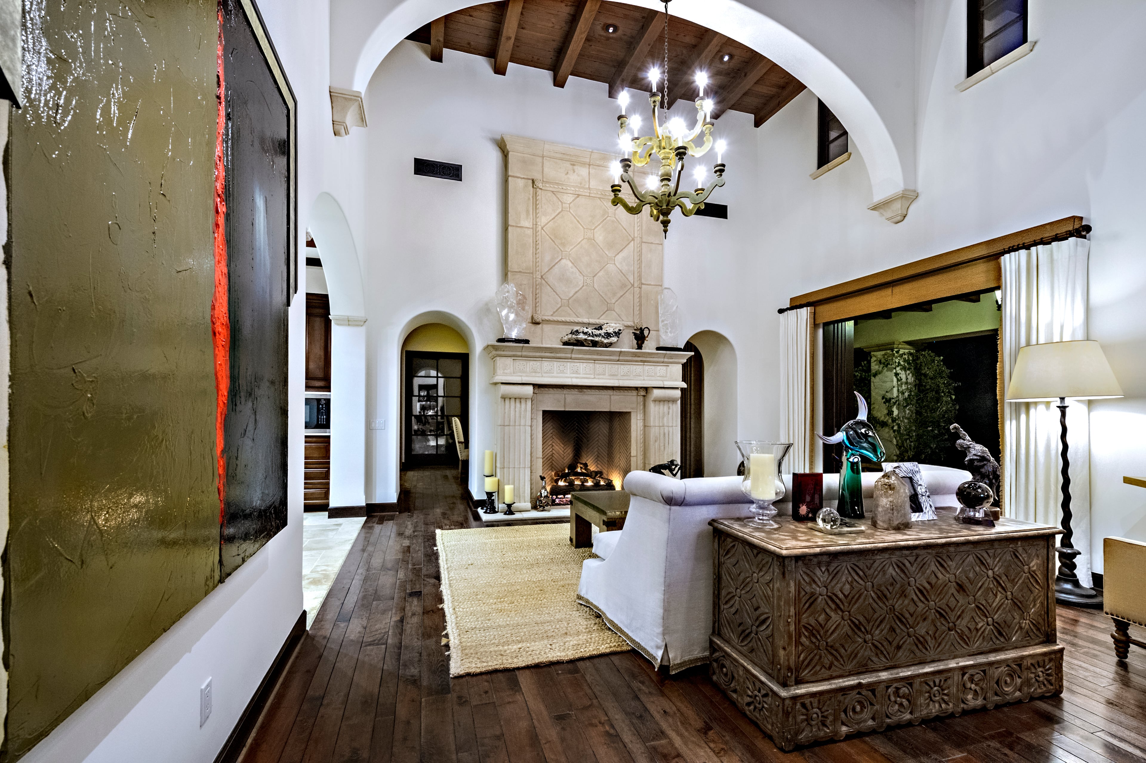 A stone fireplace is the focal point on one wall of the living room. Rocky star and all-around action movie legend Sylvester Stallone has put his desert home in a gated La Quinta, Calif., community up for sale at $4.2 million. The 5,173-square-foot, four-bedroom, 4.5-bathroom home features details such as arched doorways, exposed beams, and plenty of space to hang his paintings, since he’s not just an actor—he’s an artist, too. Listing courtesy of Josh Reef, Hurwitz James Company