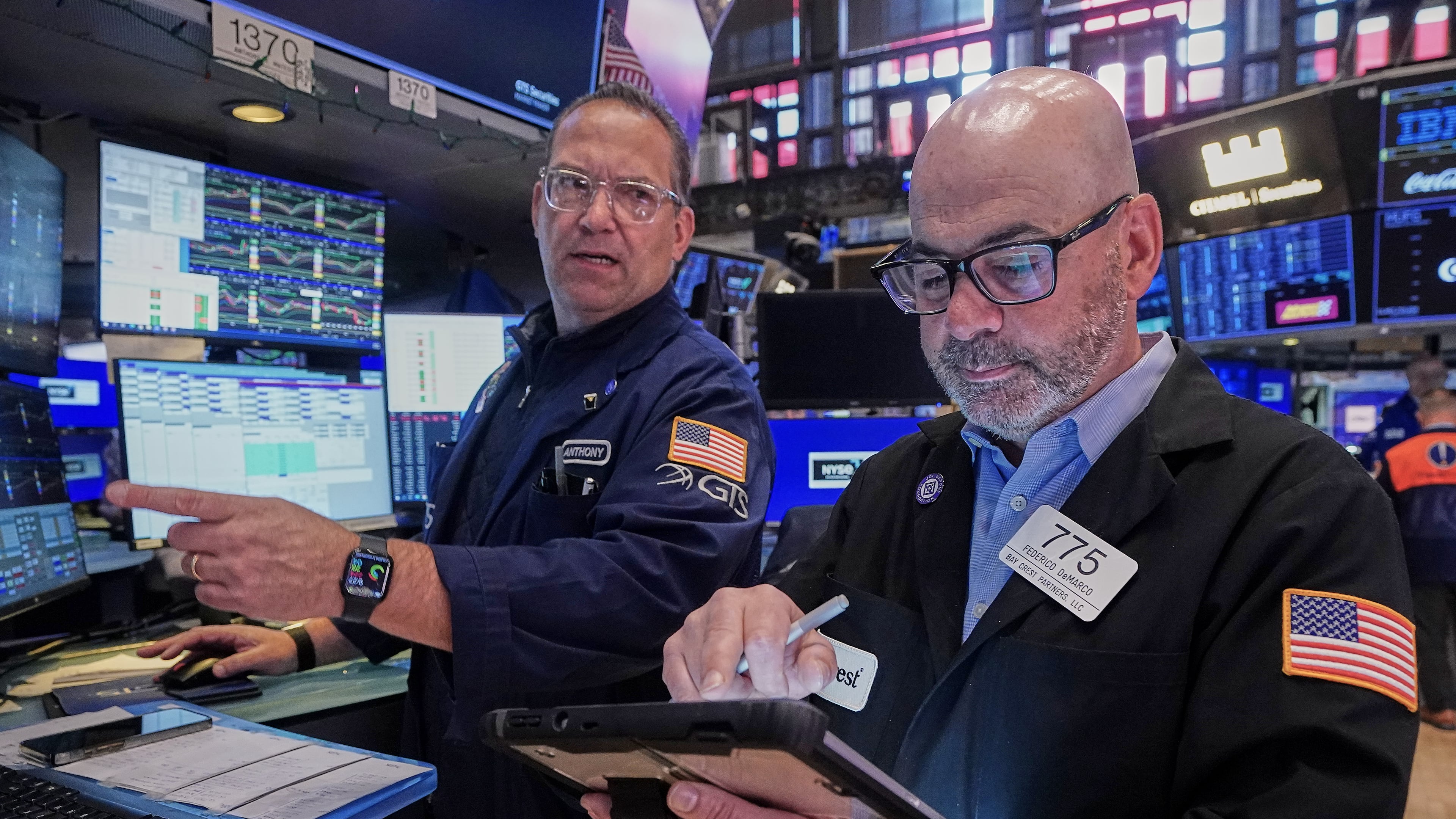 Specialist Anthony Matesic, left, and trader Fred Demarco work on the floor of the New York Stock Exchange, Friday, May 22, 2026. (AP Photo/Richard Drew)