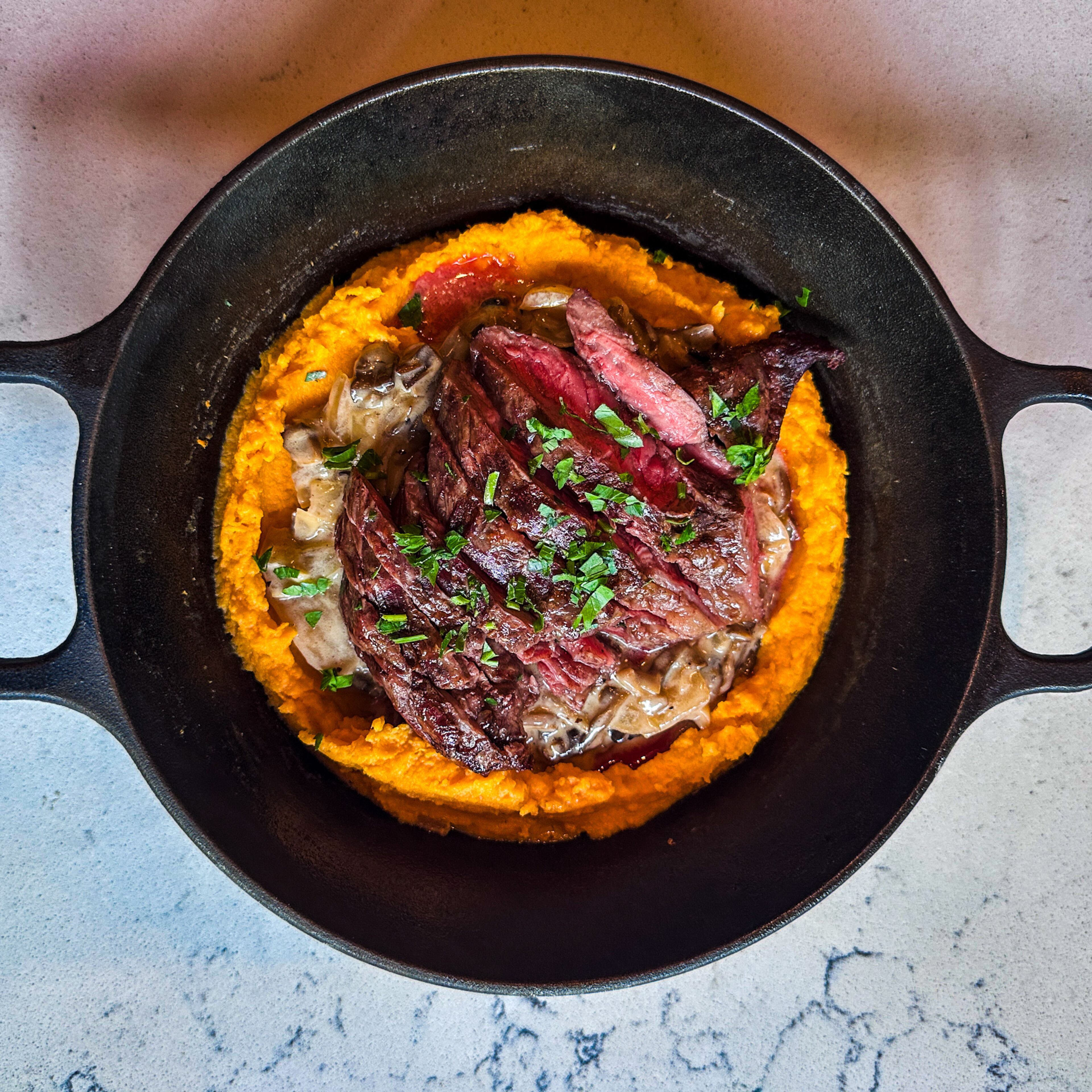 A weekend special at Belen Bistro features an Argentine cut of steak called vacio, served over mashed sweet potatoes with a mushroom sauce. (Courtesy of Belen Bistro & Market)
