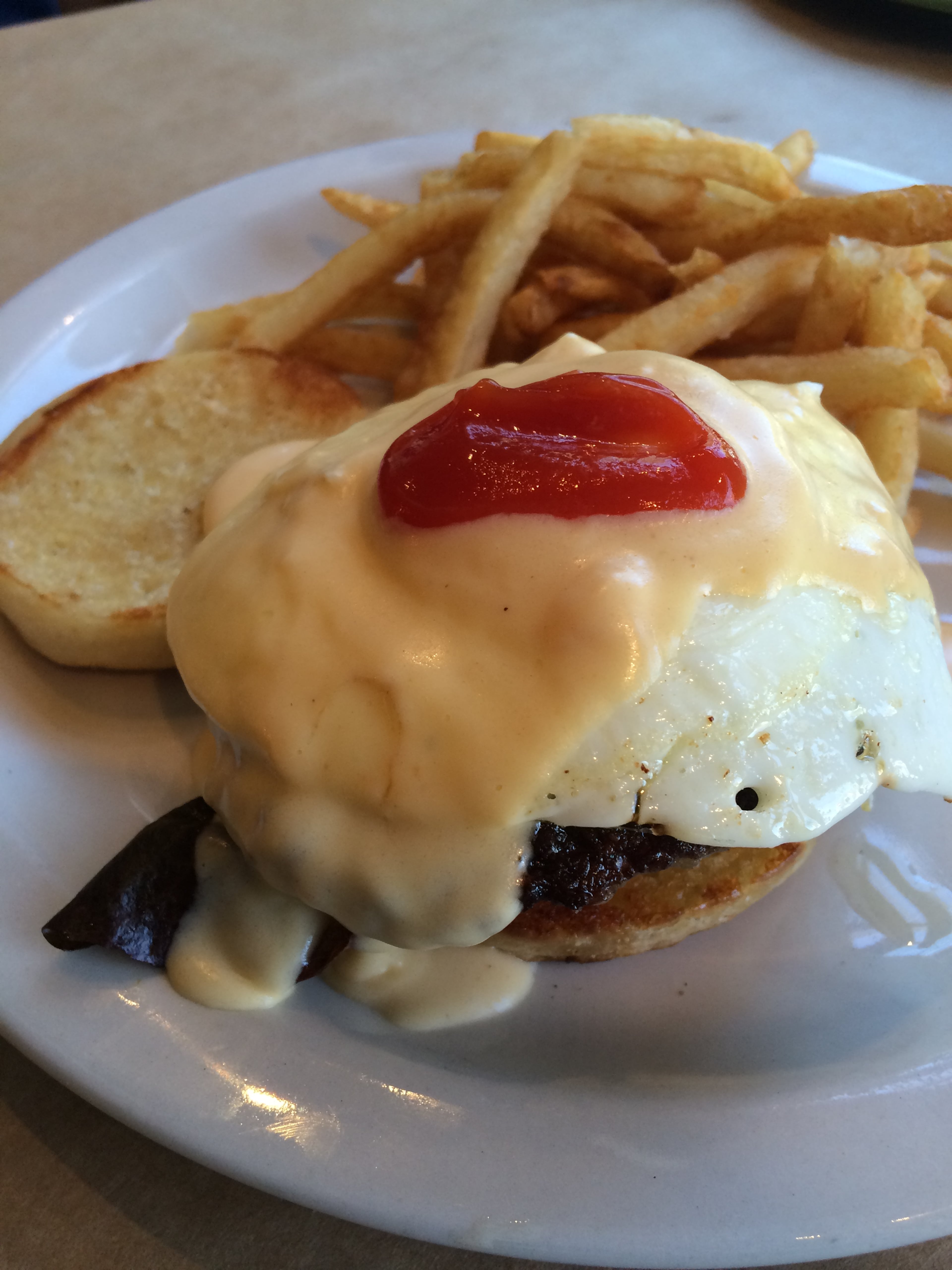Egg sandwich with pork sausage, over-easy egg and Mornay sauce with a side of fries at One Eared Stag. Read more here. / Photo by Ligaya Figueras