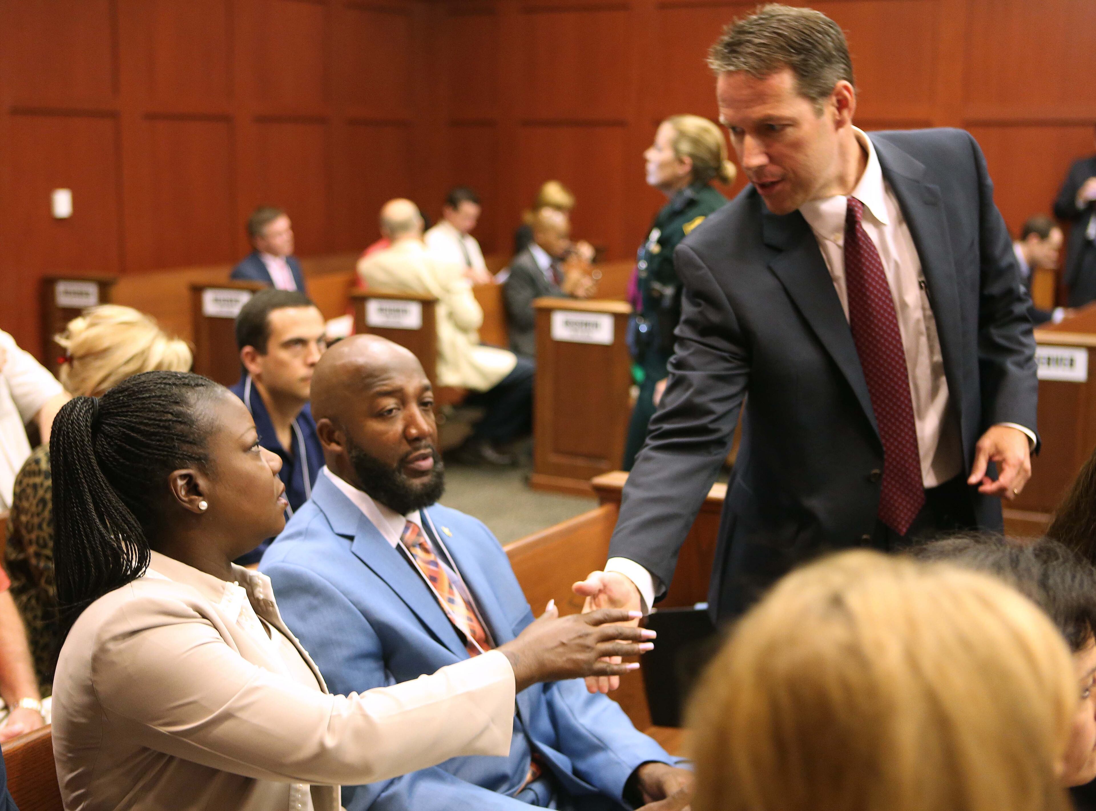 The parents of Trayvon Martin, Sybrina Fulton, left, and Tracy Martin, center, are greeted by assistant state attorney John Guy during the George Zimmerman trial in Seminole circuit court, in Sanford, Fla., Monday, June 24, 2013. Zimmerman has been charged with second-degree murder for the 2012 shooting death of Trayvon Martin. (AP Photo/Orlando Sentinel, Joe Burbank,Pool)