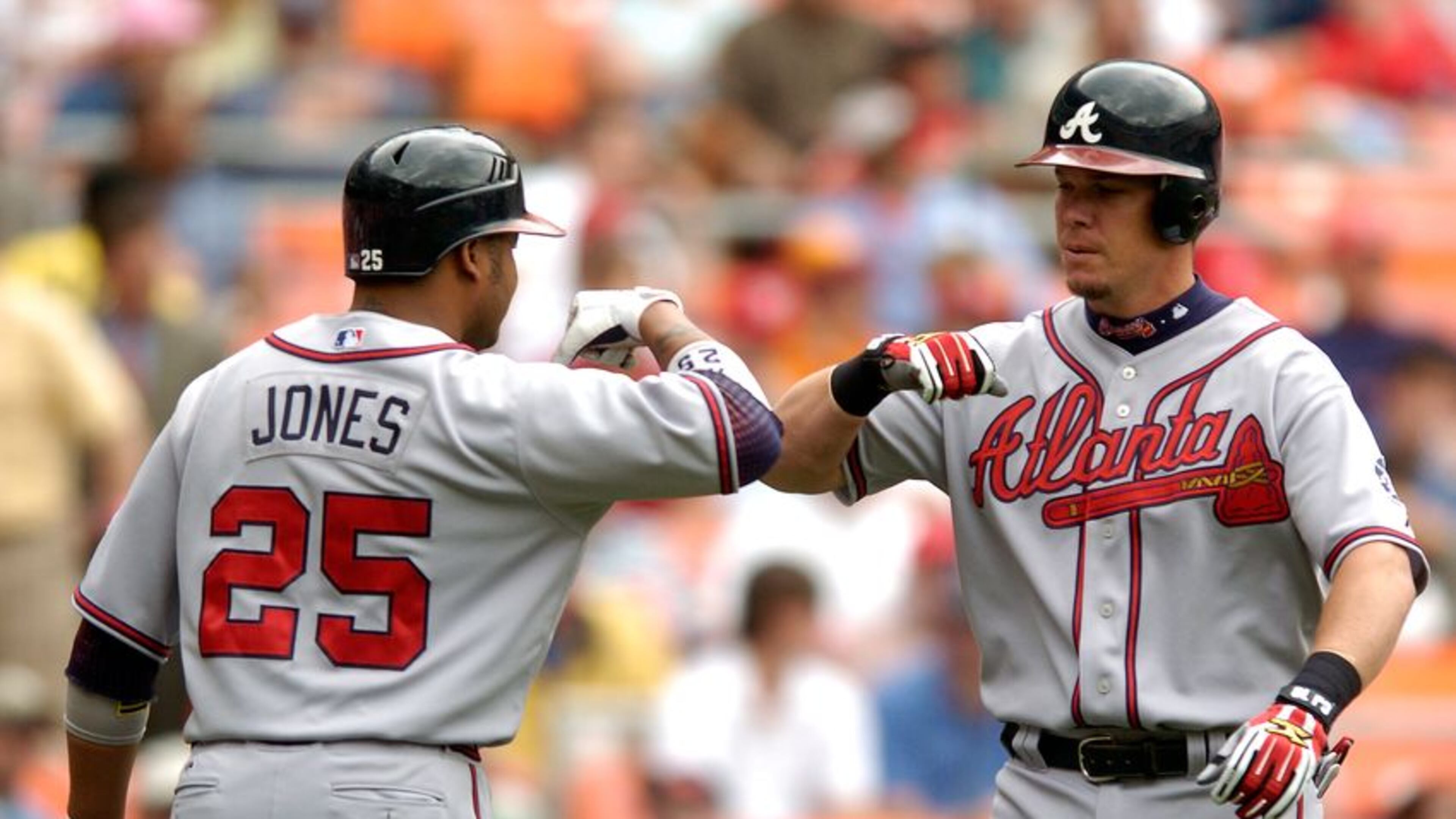 Andruw Jones (left) began a guest-instructor stint at Braves spring training Sunday, and Chipper Jones (right) is to be in camp Monday. (Getty Images)