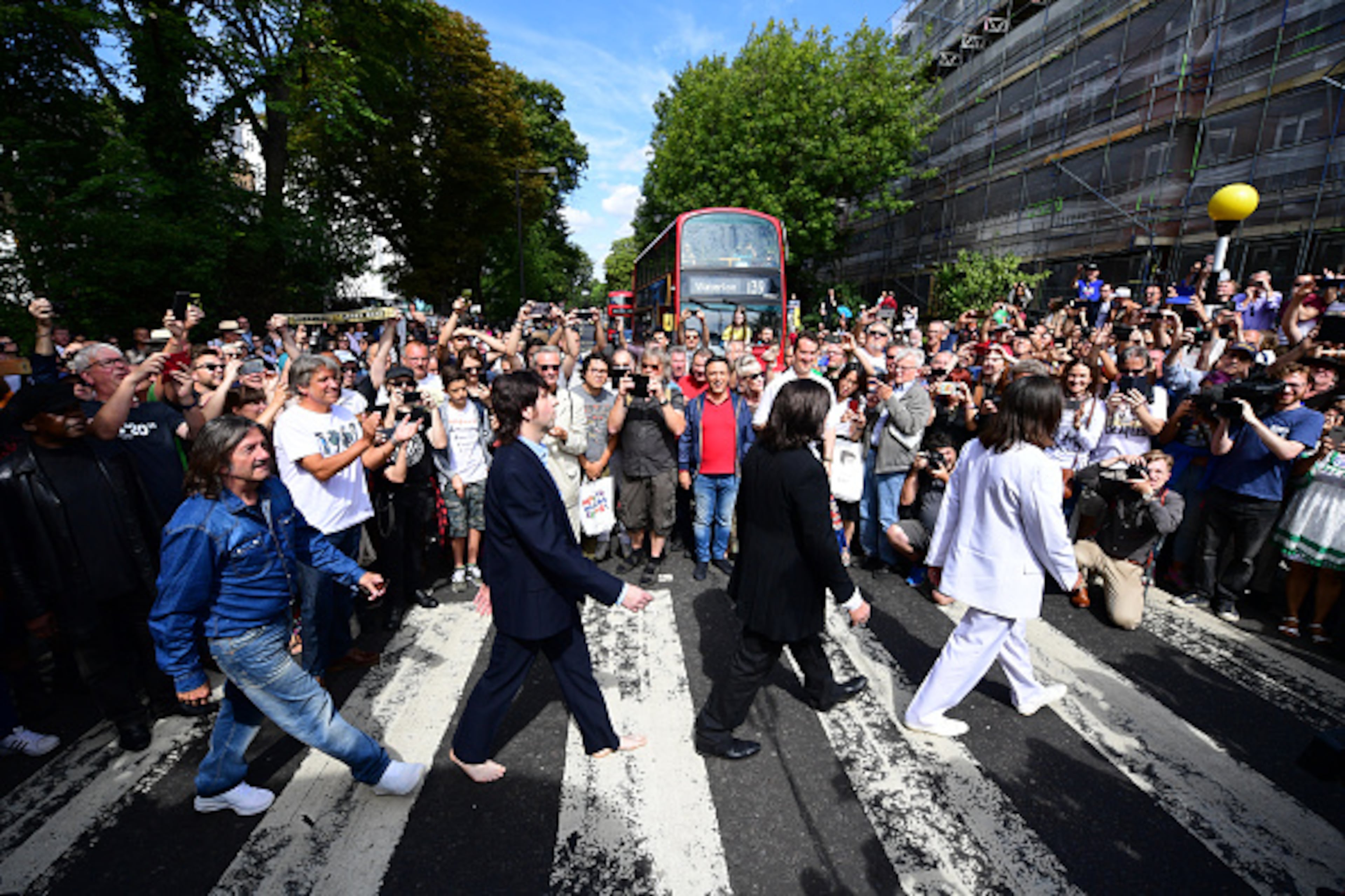 LONDON, ENGLAND - AUGUST 08: Beatles impersonators recreate the iconic 'Abbey Road' photograph made 50 years ago today, on August 8, 2019 in London, England. 50 years ago today, John Lennon, Paul McCartney, George Harrison and Ringo Starr held up traffic on the zebra crossing outside their recording studio in north London to get the cover shot for the album, Abbey Road. (Photo by Leon Neal/Getty Images)
