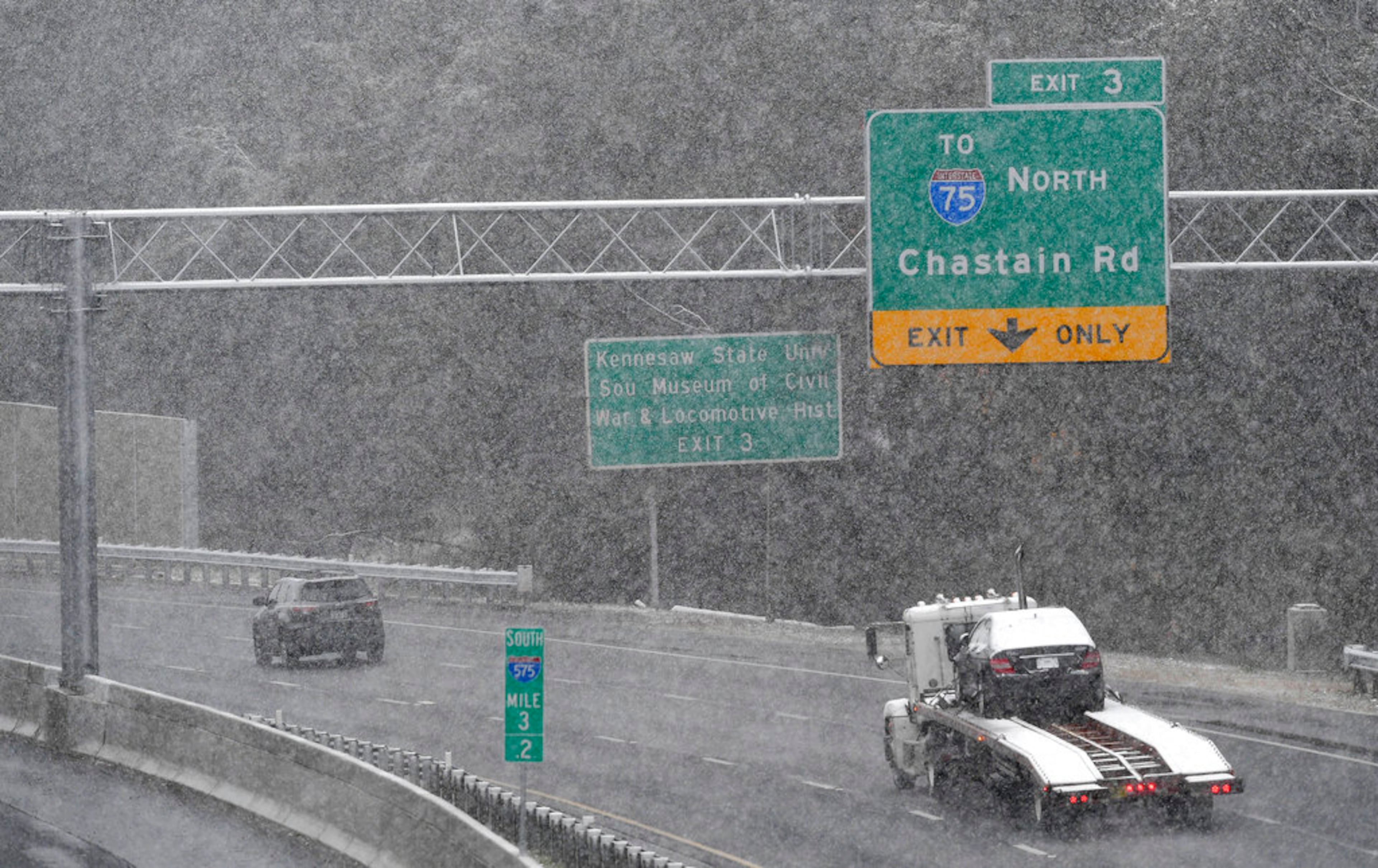 Traffic moves south in a moderate snow, Friday, Dec. 8, 2017, in Kennesaw, Ga. The forecast called for a wintry mix of precipitation across several Deep South states. (AP Photo/Mike Stewart)