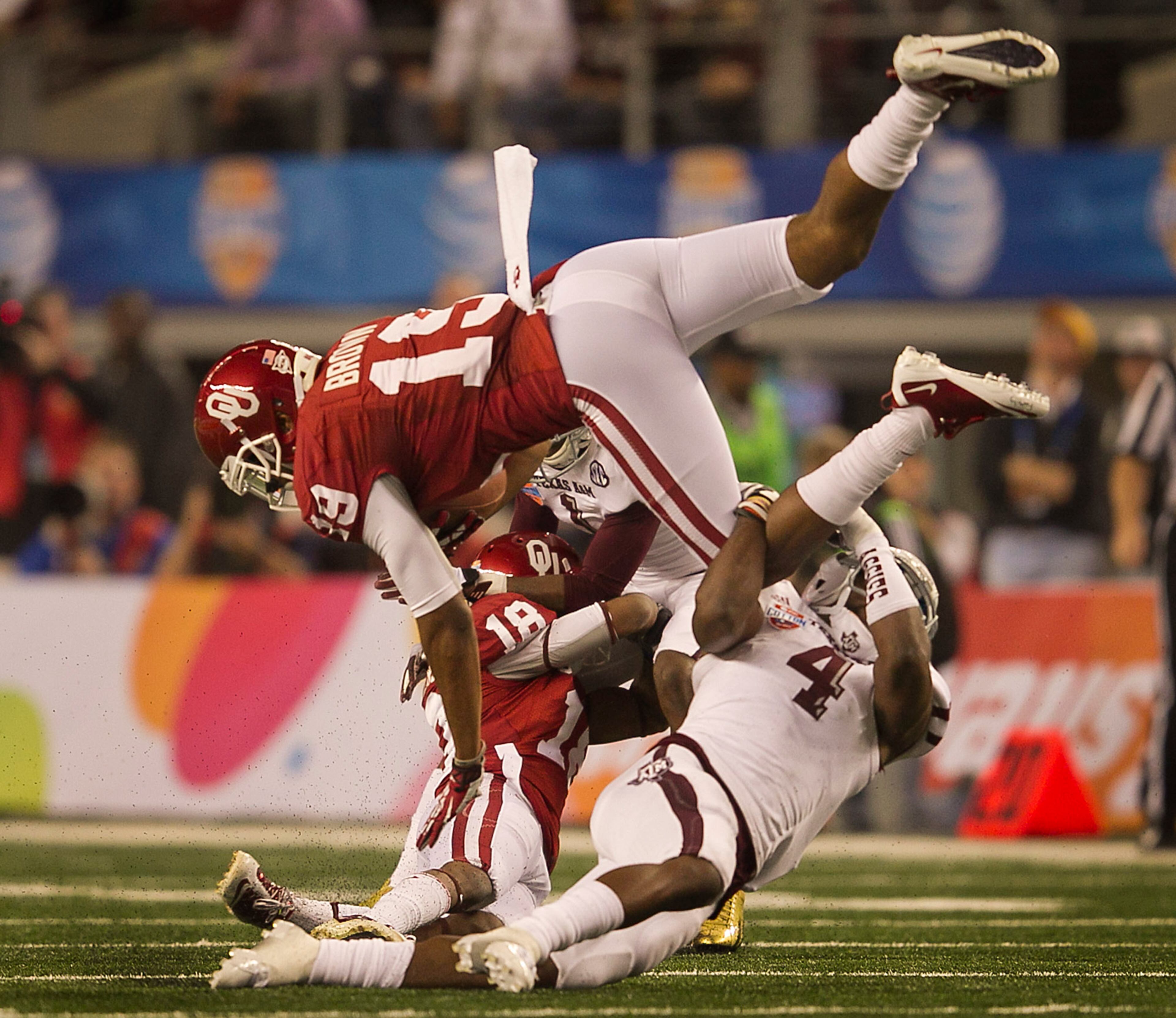 Texas A&M's Toney Hurd, Jr., (4) wraps up Oklahoma's Justin Brown (19) on a short catch during the first half of the 77th AT&T Cotton Bowl Classic held at the Cowboy Stadium in Arlington, Texas, on Friday, January 4, 2013. Rodolfo Gonzalez / Austin American-Statesman