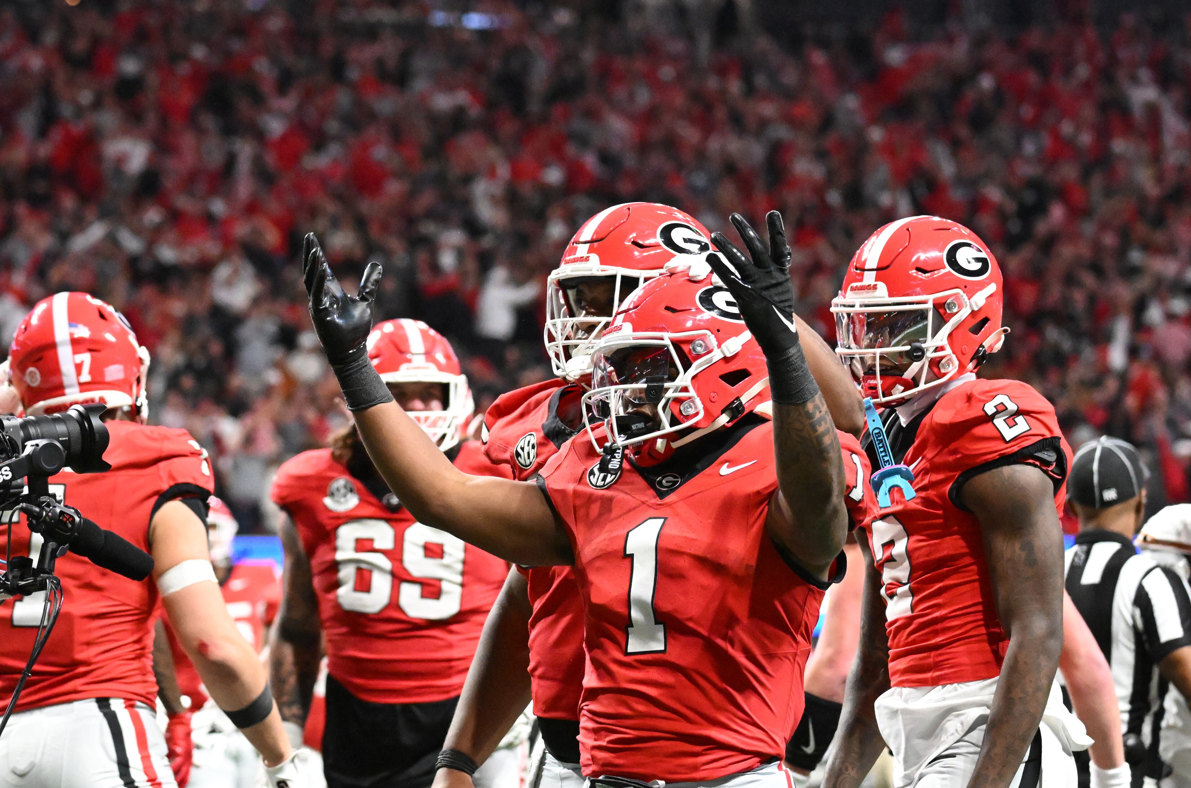 Georgia running back Trevor Etienne (1) celebrates with teammates after scoring a touchdown during the second half in the SEC Championship football game at the Mercedes-Benz Stadium, Saturday, December 7, 2024, in Atlanta. Georgia won 22-19 over Texas in overtime. (Hyosub Shin / AJC)