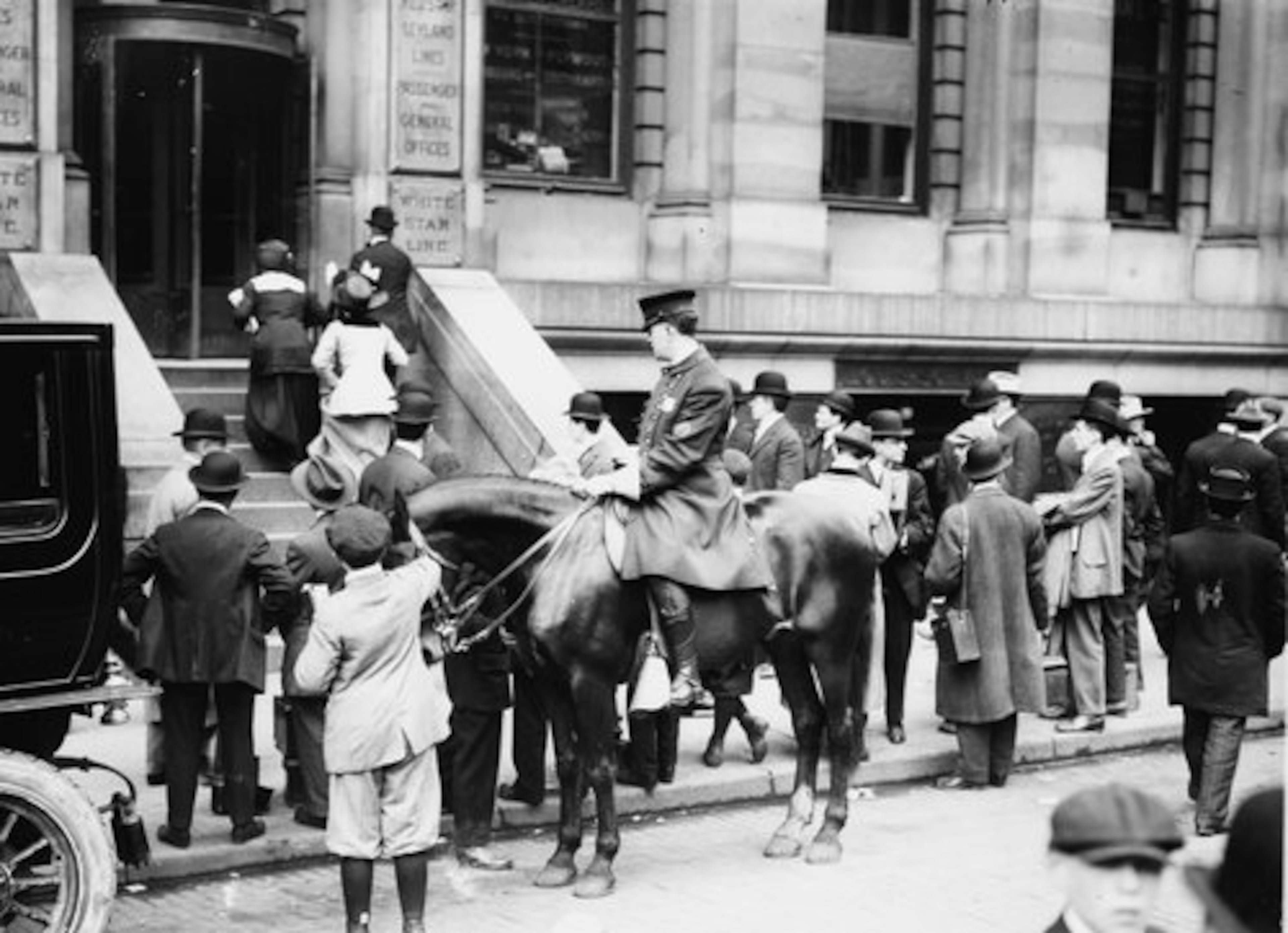 FILE -- Eager to hear the latest news about the sinking of the RMS Titanic, people gather outside the offices of the White Star Line in New York on April 15, 1912.