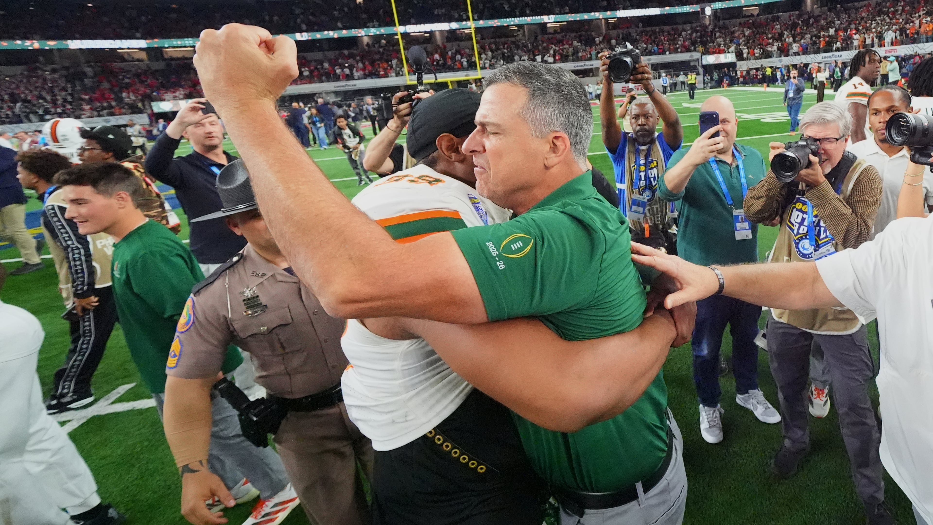 Miami head coach Mario Cristobal, right, hugs defensive lineman Ahmad Moten Sr. following the Cotton Bowl College Football Playoff quarterfinal game against Ohio State Wednesday, Dec. 31, 2025, in Arlington, Texas. (AP Photo/Julio Cortez)