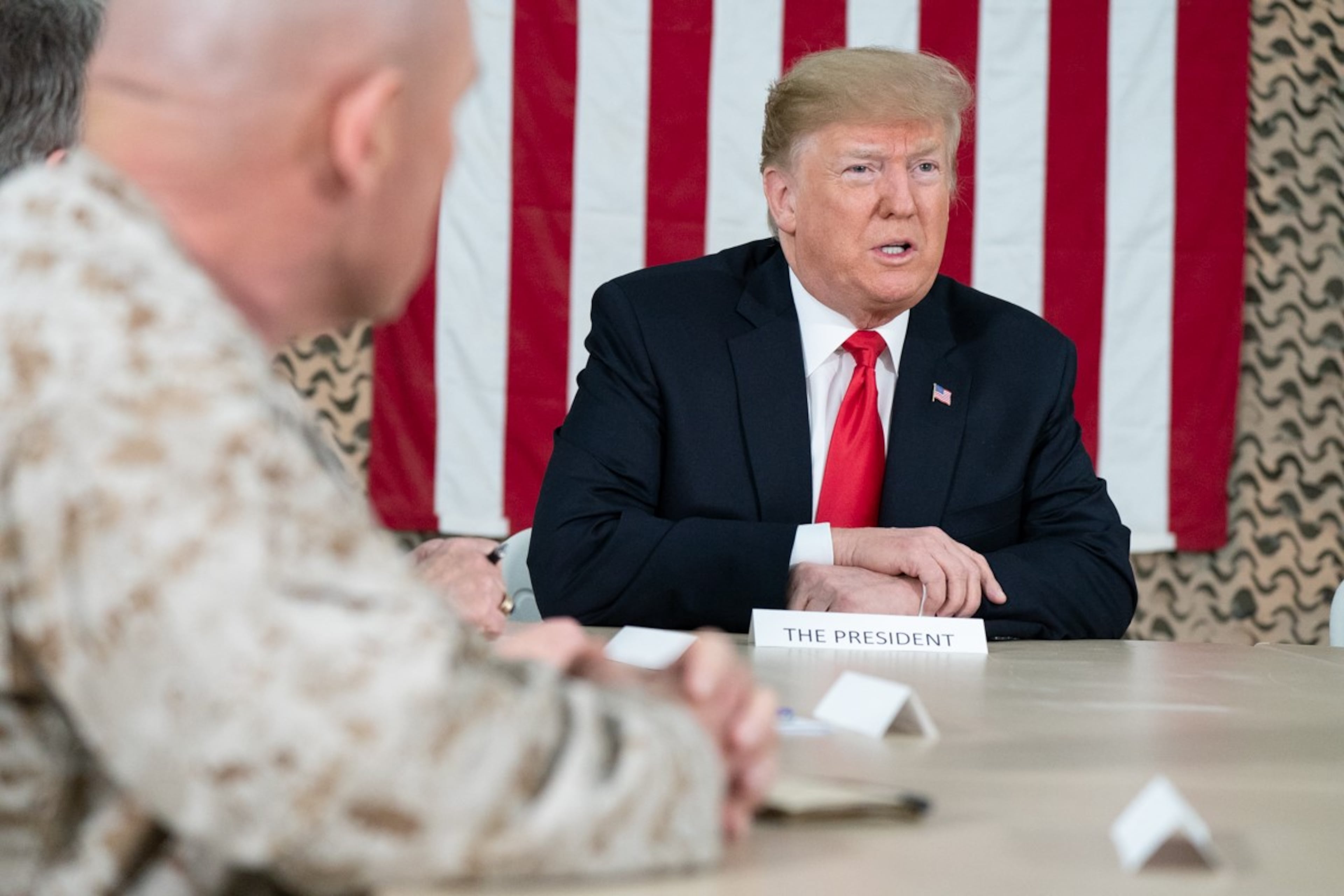President Donald J. Trump, joined by First Lady Melania Trump, speaks with reporters during a briefing with military leadership members Wednesday, December 26, 2018, at the Al-Asad Airbase in Iraq.