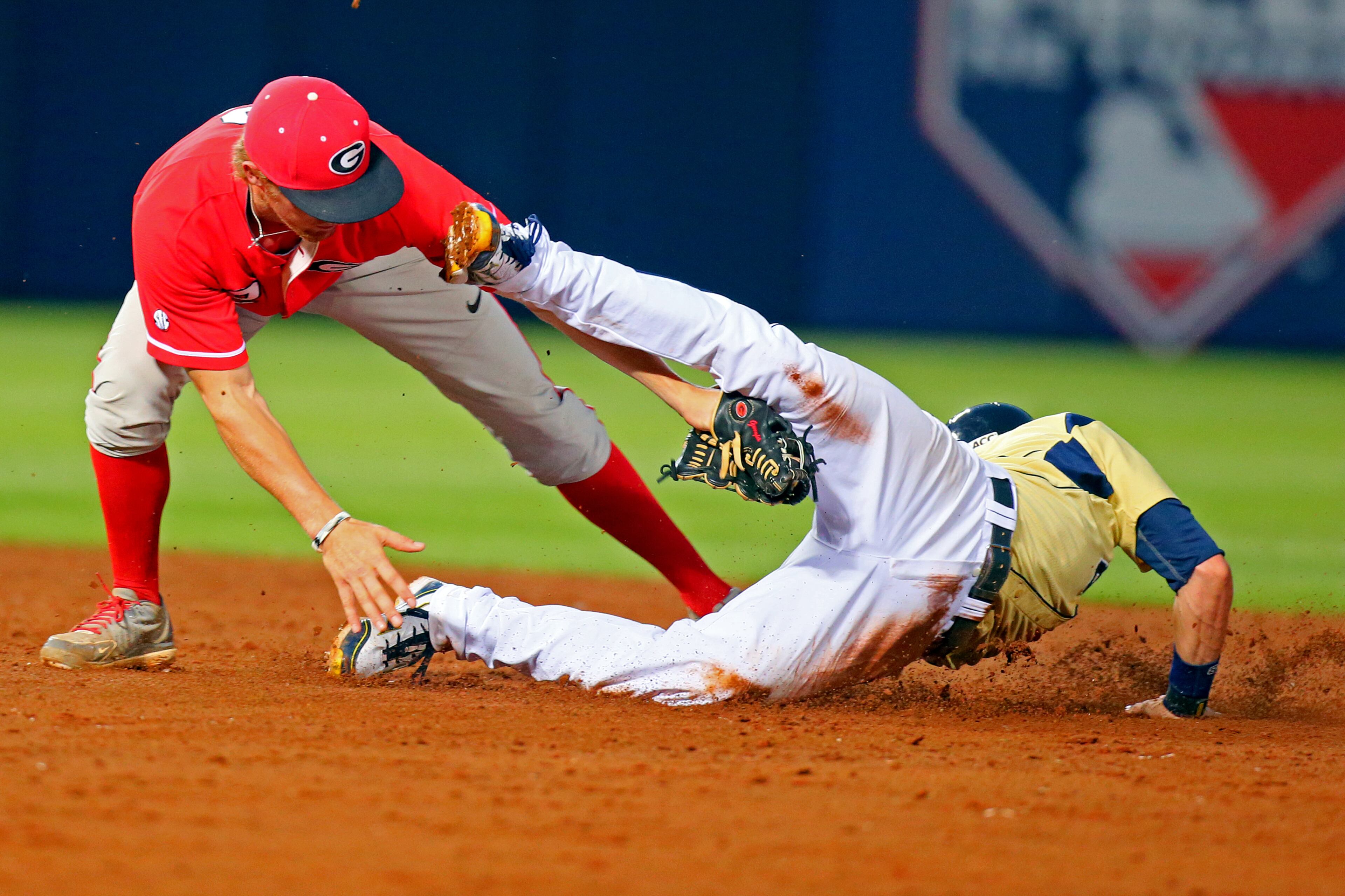 Georgia Tech base runner Kyle Wren is tagged out attempting to steal second by Georgia second baseman Nelson Ward during the third inning.
