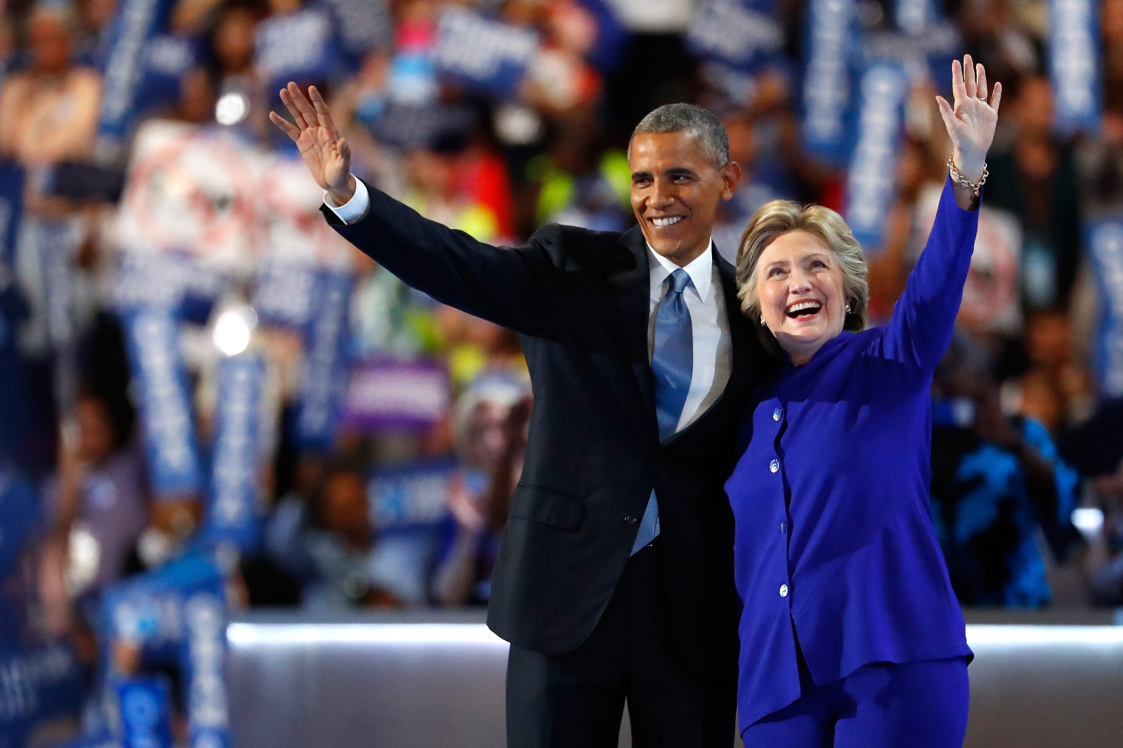 President Barack Obama and Democratic presidential candidate Hillary Clinton wave to the crowd on the third day of the Democratic National Convention at the Wells Fargo Center, July 27, 2016 in Philadelphia, Pennsylvania. The four-day Democratic National Convention kicked off July 25. (Photo by Aaron P. Bernstein/Getty Images)