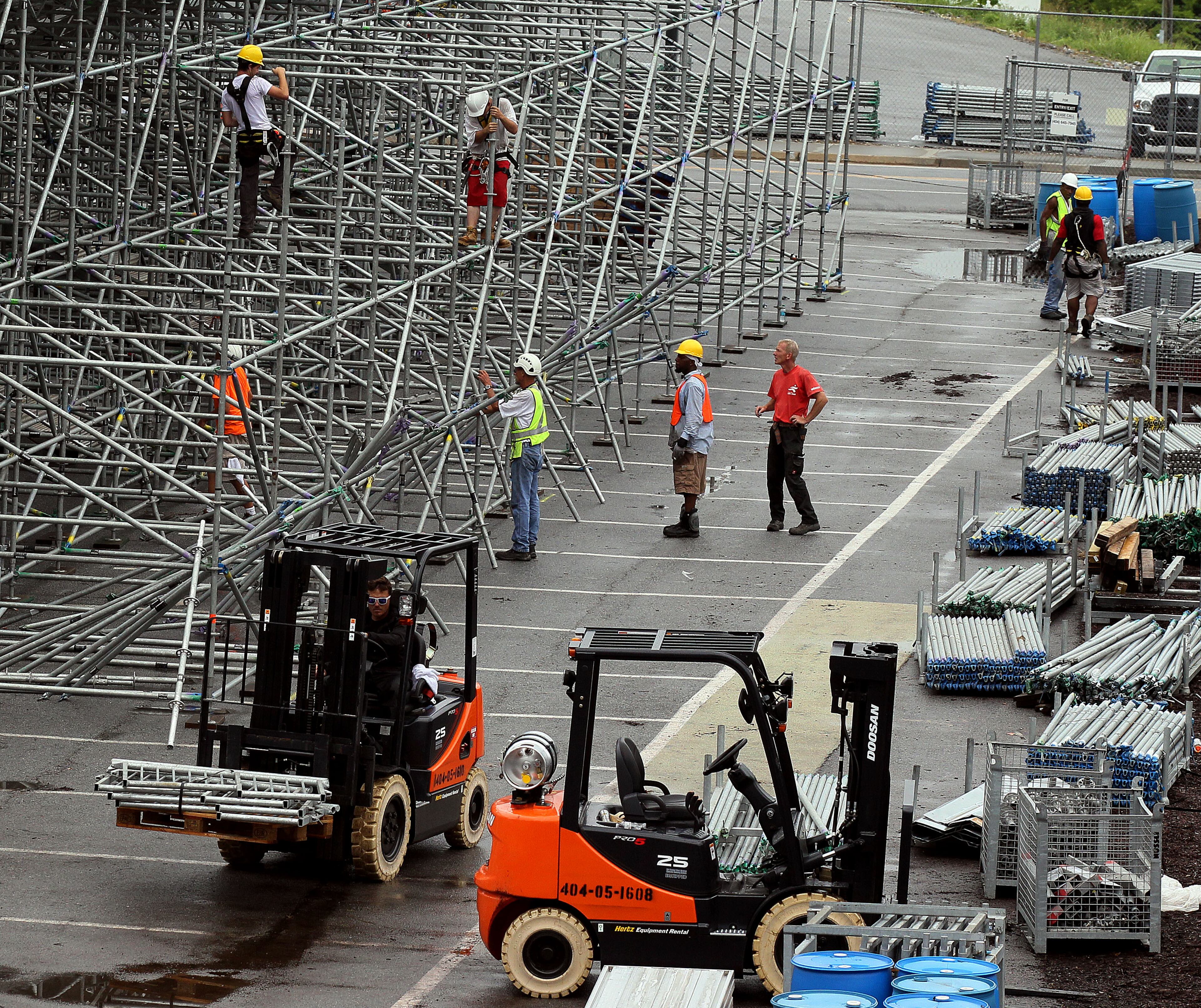 Crews construct the grand stands for the upcoming BB&T Atlanta Open men's pro tennis event at Atlantic Station.
