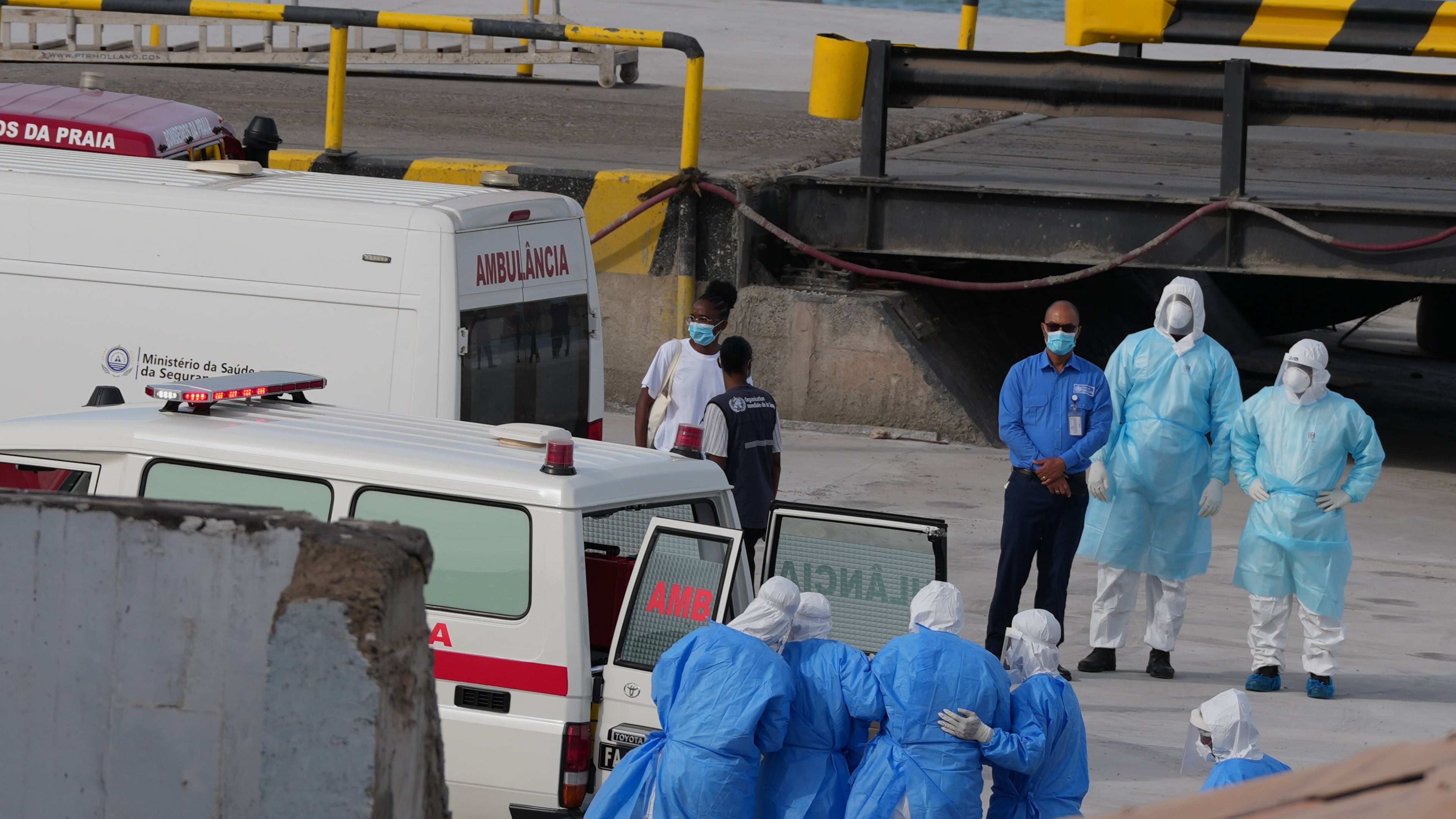 Health workers in protective gear evacuate patients from the MV Hondius cruise ship into an ambulance at a port in Praia, Cape Verde, on Wednesday, May 6, 2026. The luxury liner had eight confirmed cases of hantavirus and two probable cases, according to the WHO. Three people died. (Misper Apawu/AP)
