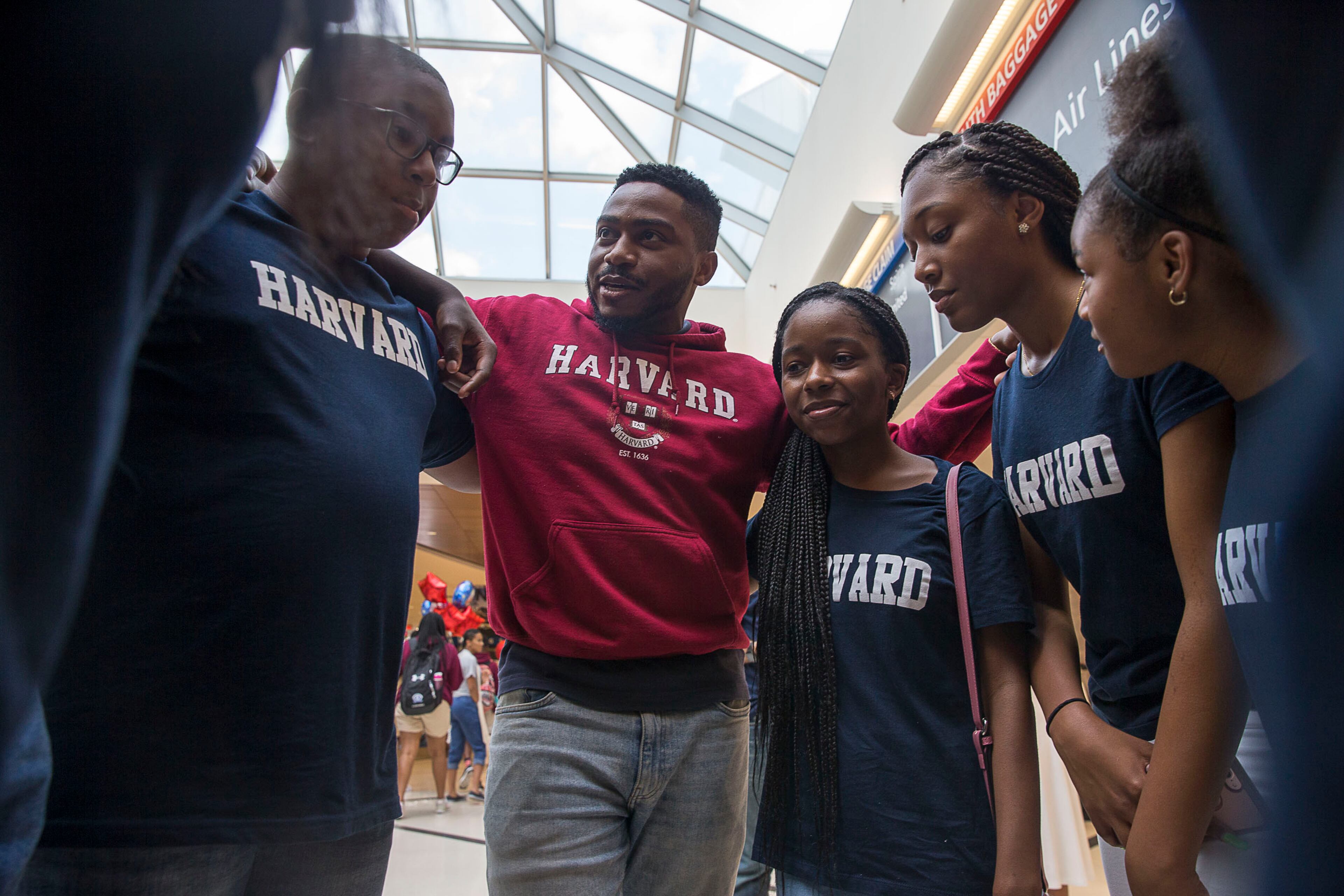 7/12/2019 -- Atlanta, Georgia -- Brandon Fleming (second from left) speaks with future members of the Harvard Diversity Project after he arrived to the domestic terminal at Hartsfield Jackson International Airport in Atlanta, Friday, July 12, 2019. (Alyssa Pointer/alyssa.pointer@ajc.com)