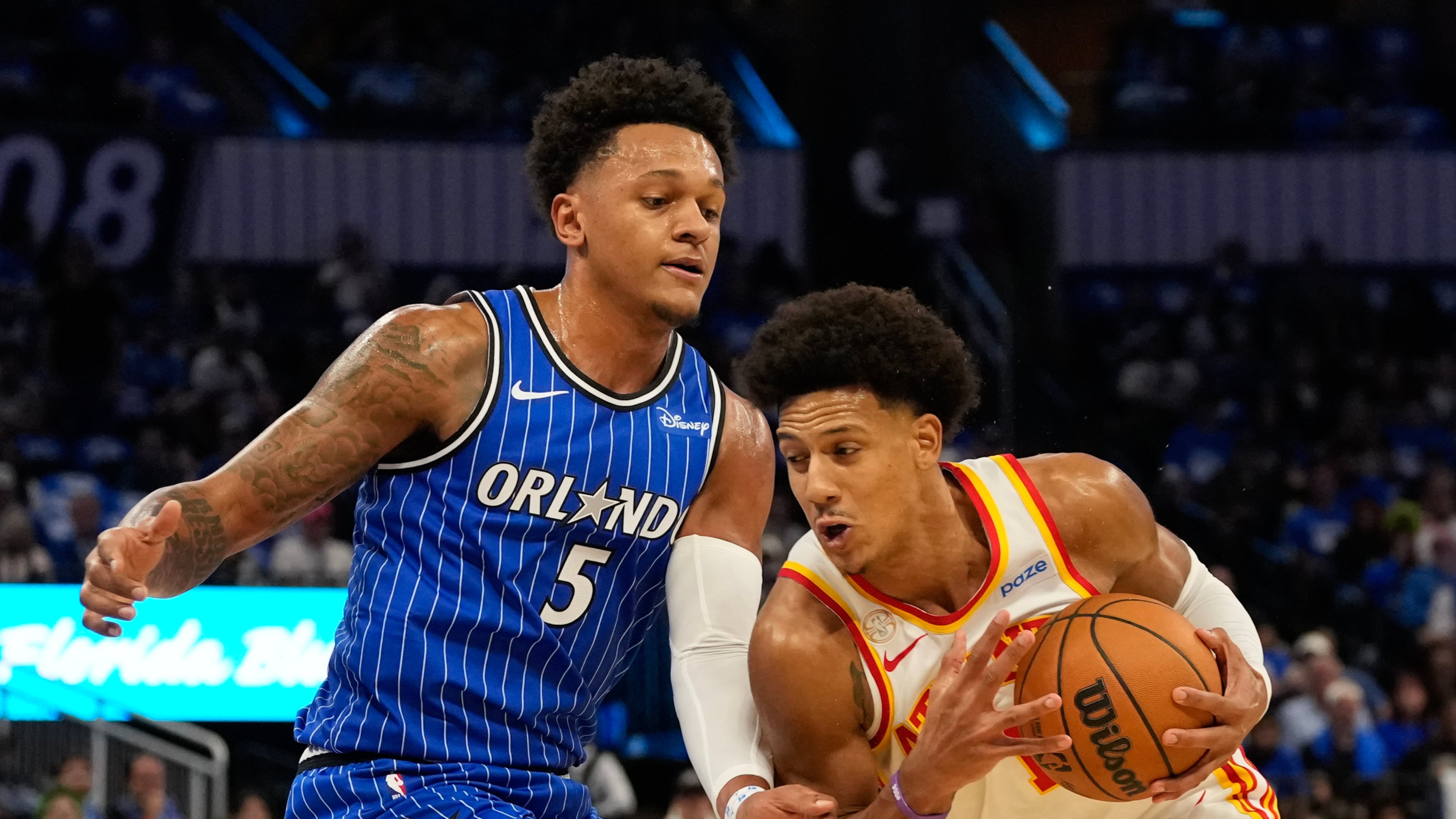 Atlanta Hawks forward Jalen Johnson drives around Orlando Magic forward Paolo Banchero during the first half of their season opener on Wednesday, Oct. 21, 2026. (John Raoux/AP)
