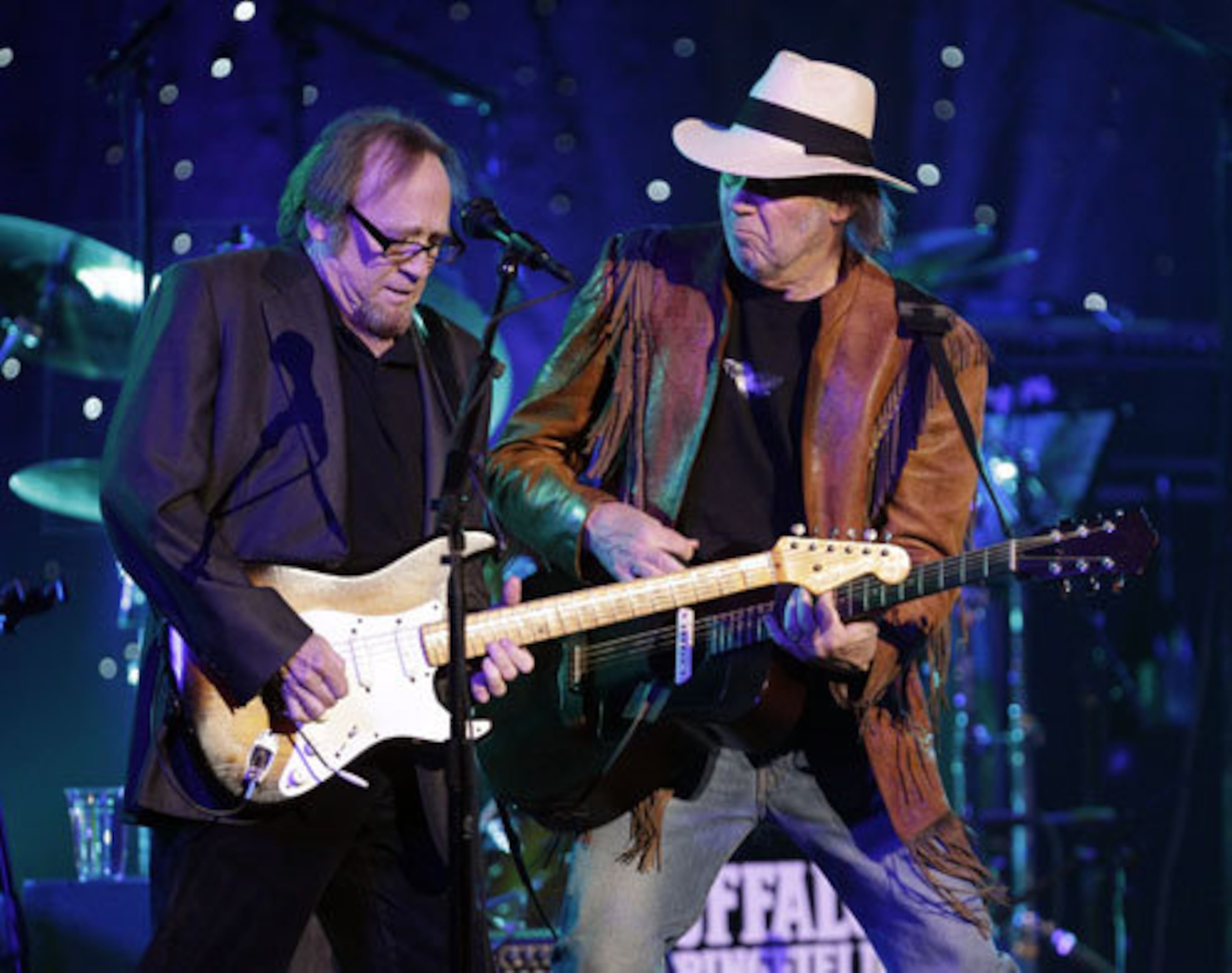 Stephen Stills, left, and Neil Young perform together.