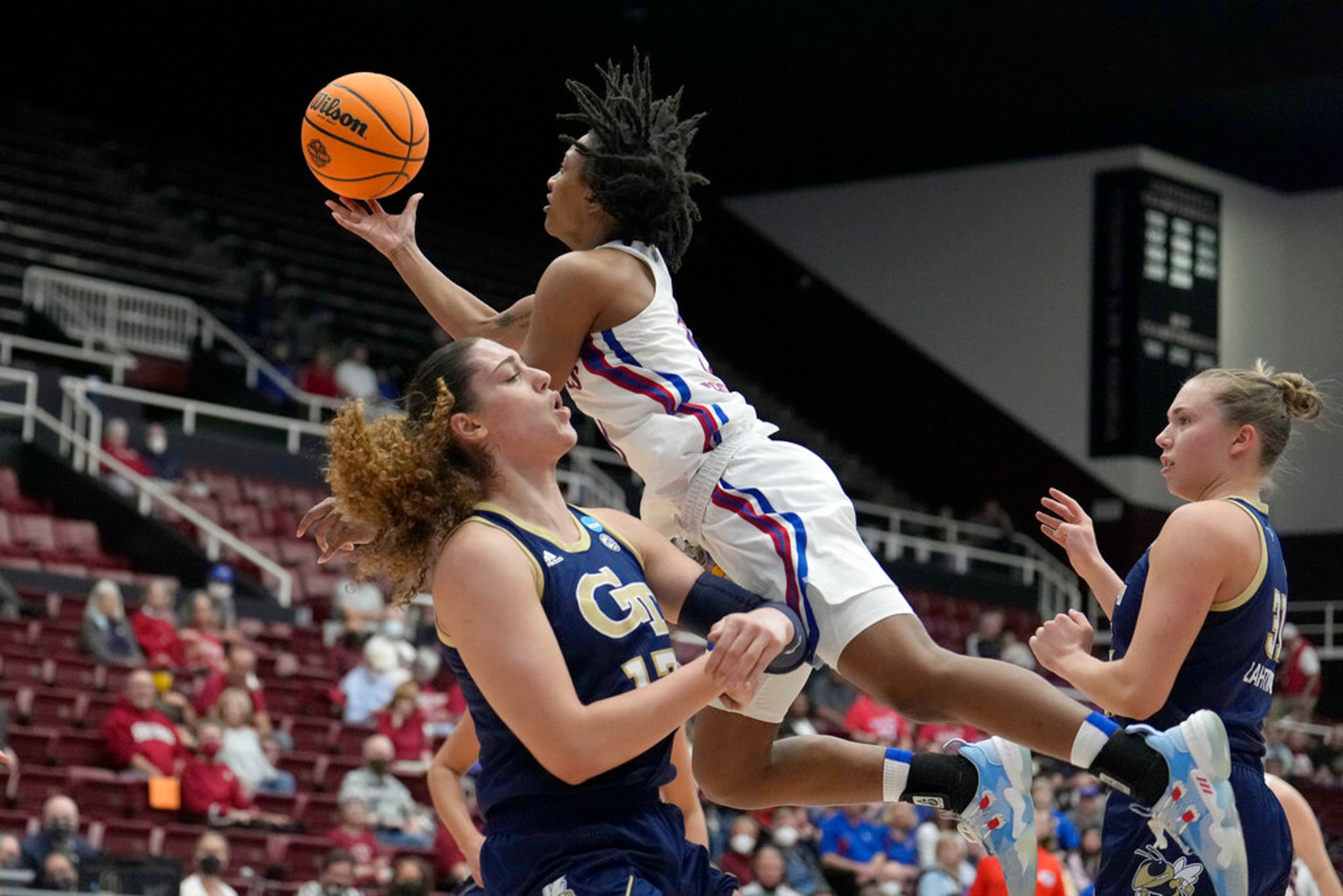 Kansas guard Aniya Thomas, top, drives to the basket against Georgia Tech forward Lorela Cubaj, left, during the first half of a first-round game in the NCAA women's college basketball tournament Friday, March 18, 2022, in Stanford, Calif. (AP Photo/Tony Avelar)