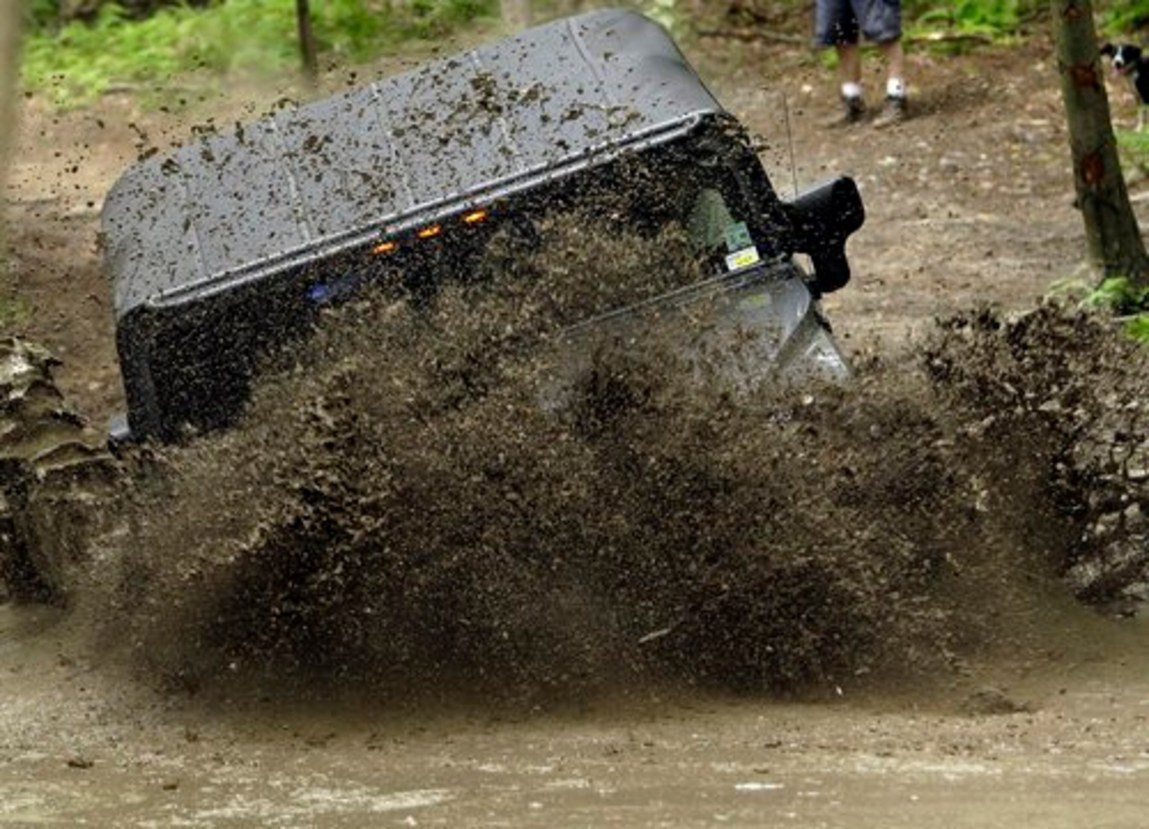 An H2 Hummer plows into a mud bath.