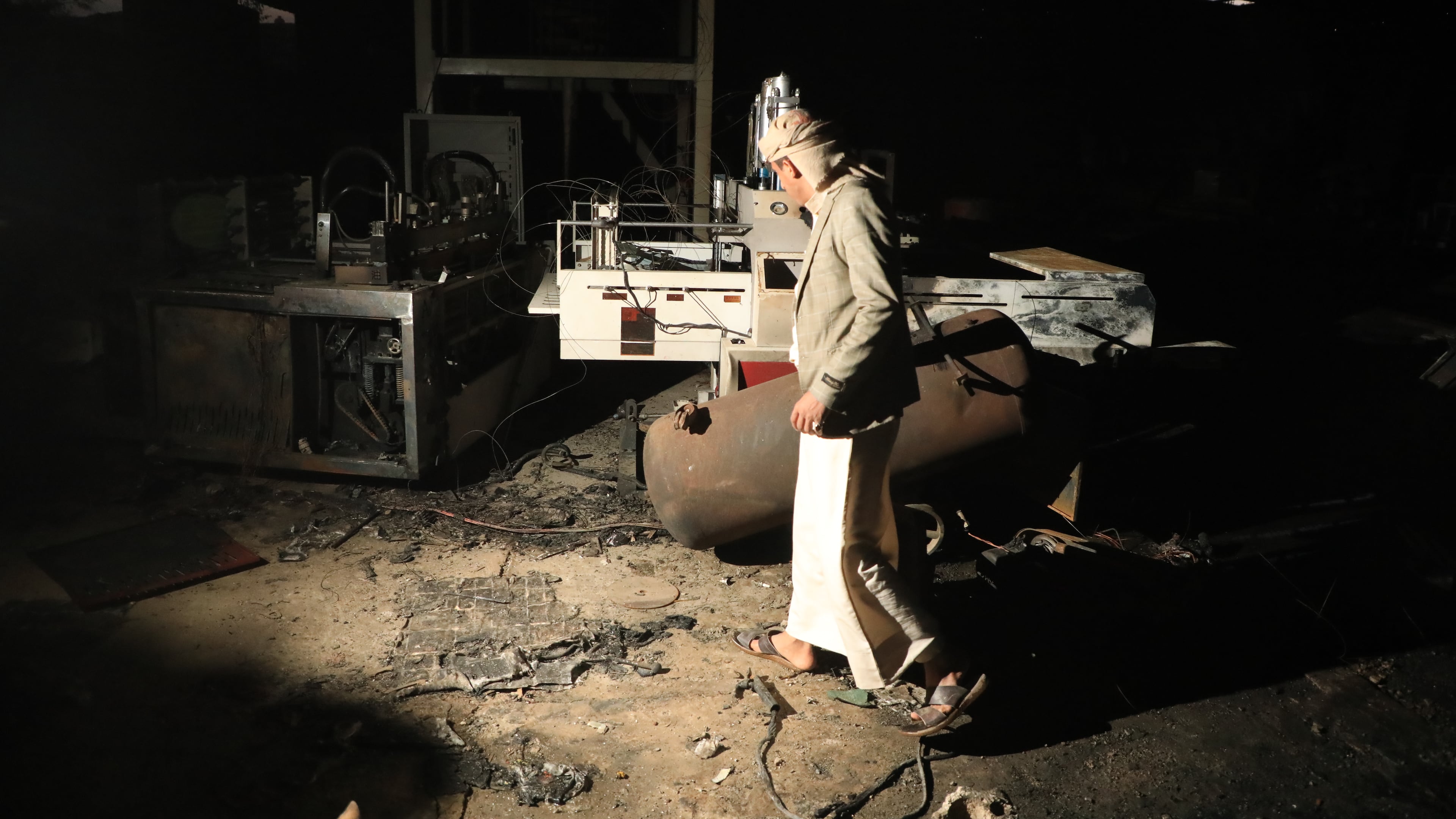 A man walks inside a damaged sponge factory in Sanaa, Yemen, Sunday, Oct. 4, 2026. (AP Photo/Osamah Abdulrahman)