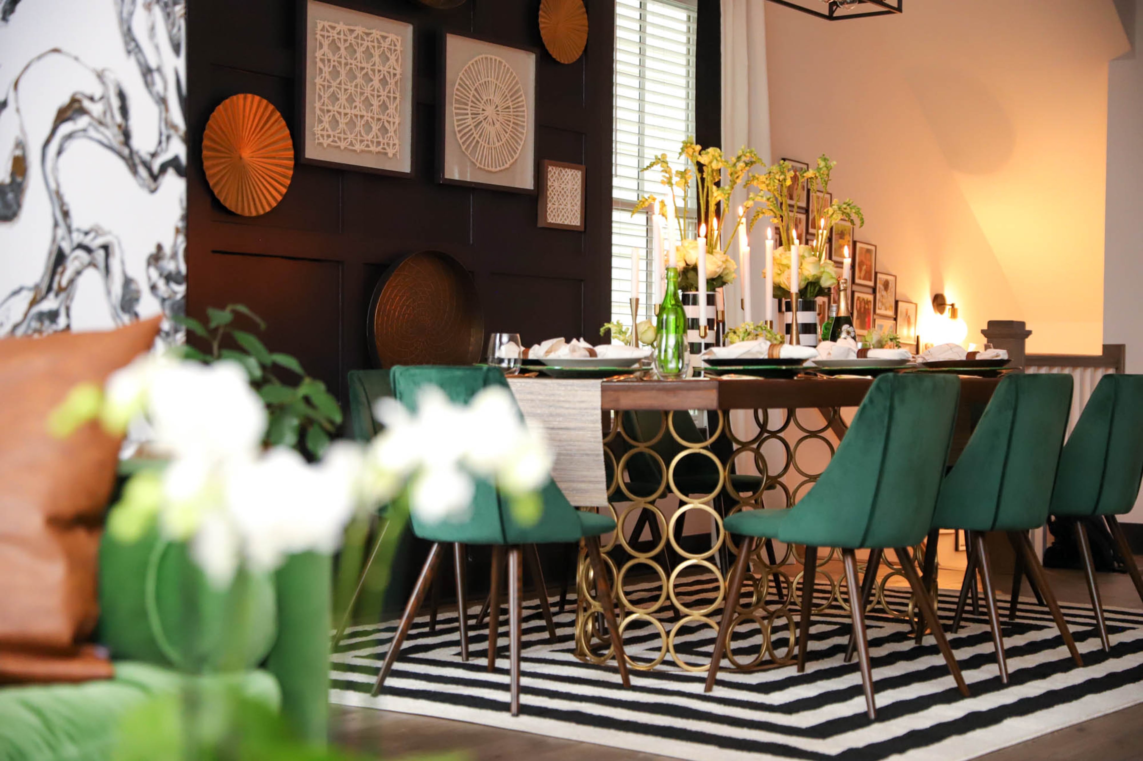 Given the very open floor plan, cohesion and a matching, yet neutral color palette were paramount for Nirjary Desai in the living, dining and kitchen spaces. She wanted a clean aesthetic — where everything “told a story and spoke to each other on the floor” — and used blacks, whites, golds, wood tones, and greens to accomplish that. Reynolds Rogers/FOR THE AJC