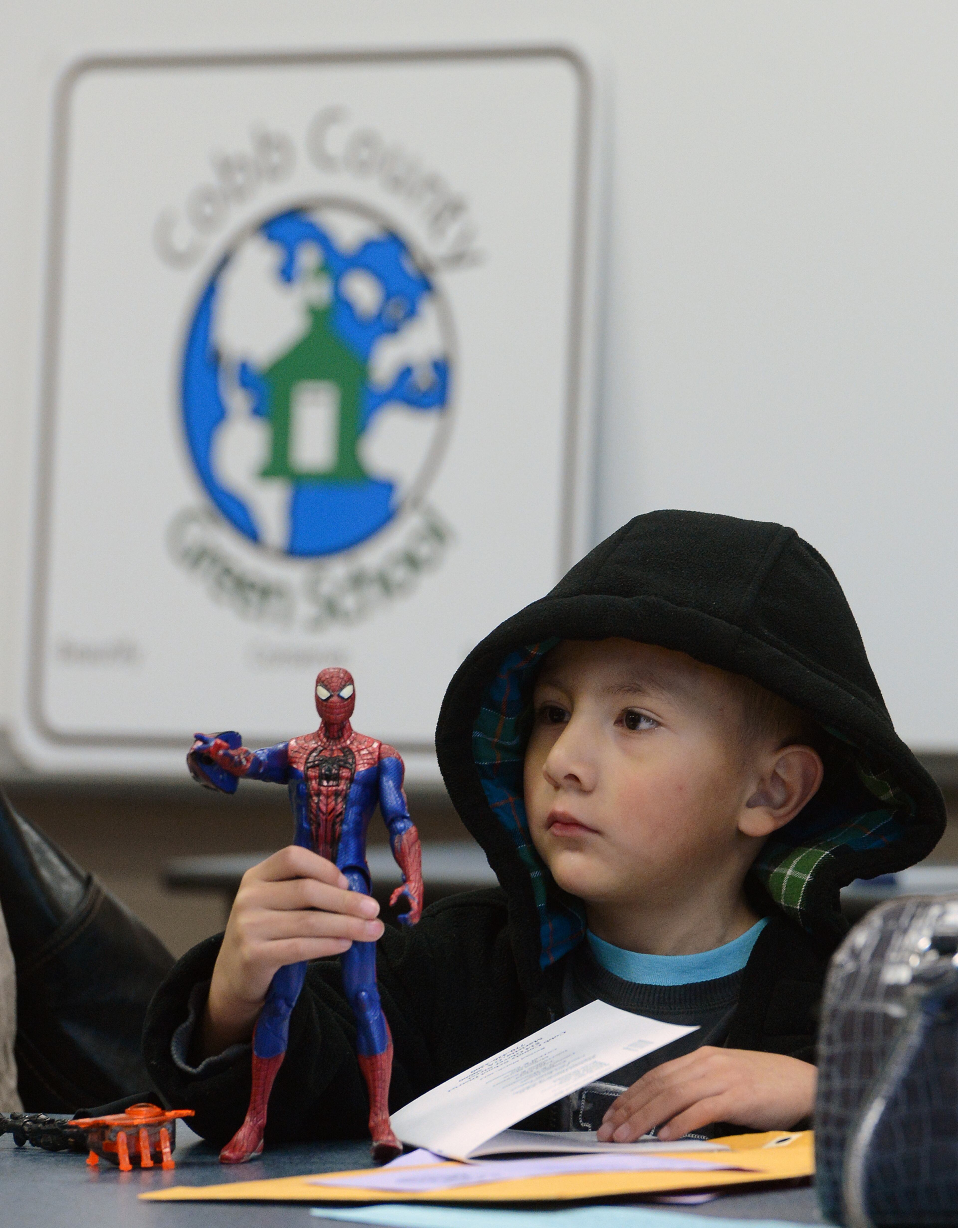 Randy Perez plays with is Spiderman action figure as his mother registers him for kindergarten at Mableton Elementary School on Wednesday, March 27, 2013. Today was his fifth birthday. Cobb County elementary schools began registering all new kindergarten students for the upcoming 2013-14 school year on today from 8:00 a.m. - 11:30 a.m. Georgia law requires that kindergarten students be five years old on or before September 1st and first grade students must be six years old on or before September 1st to be registered.