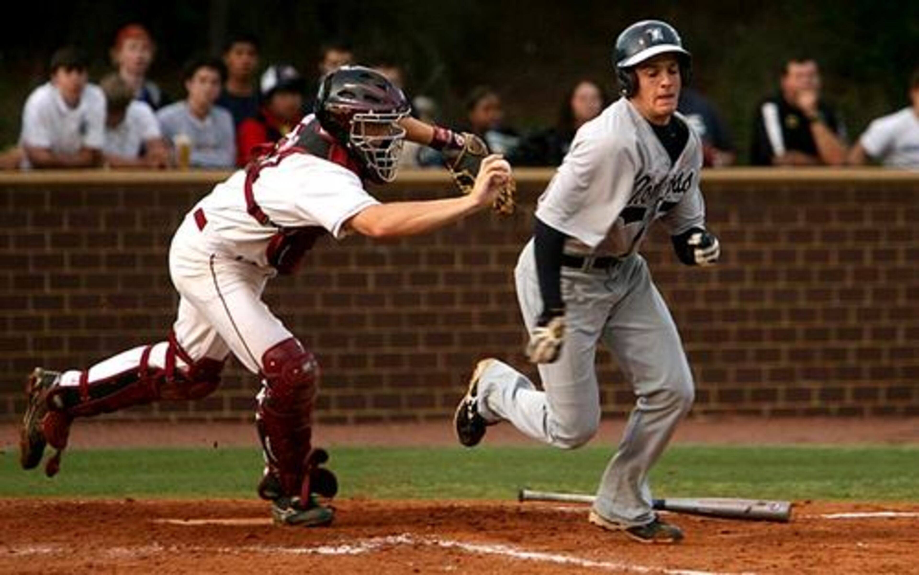 Broncos catcher Seth Adkins (left) goes for the tag on Norcross' Matt Kinney in the fourth. Adkins threw to first for the out on Kinney.