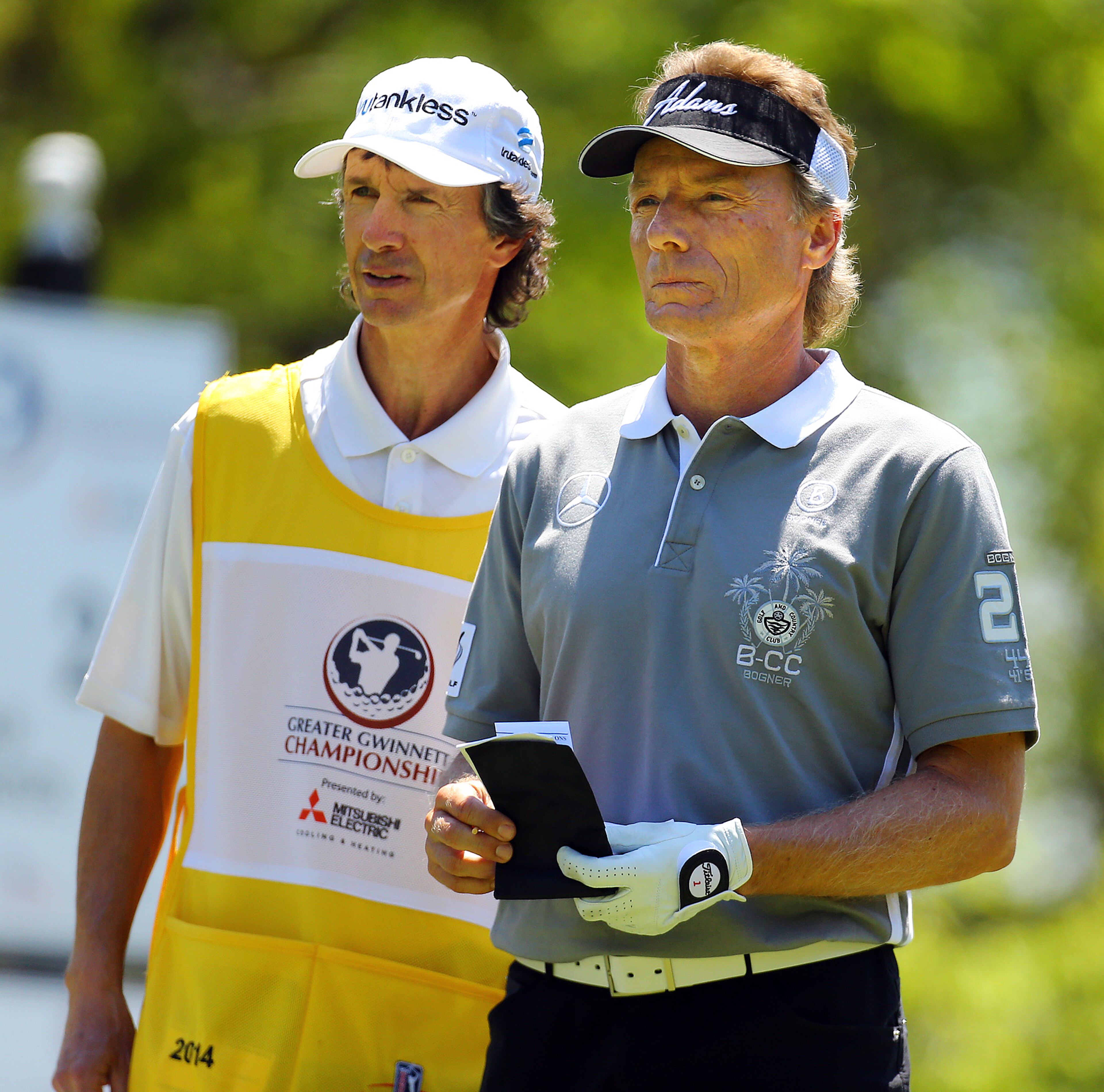 Bernhard Langer of Munich, Germany, confers with his caddy Terry Holt before teeing off on hole No. 2 during his final round of the Greater Gwinnett Championshi. CURTIS COMPTON / CCOMPTON@AJC.COM