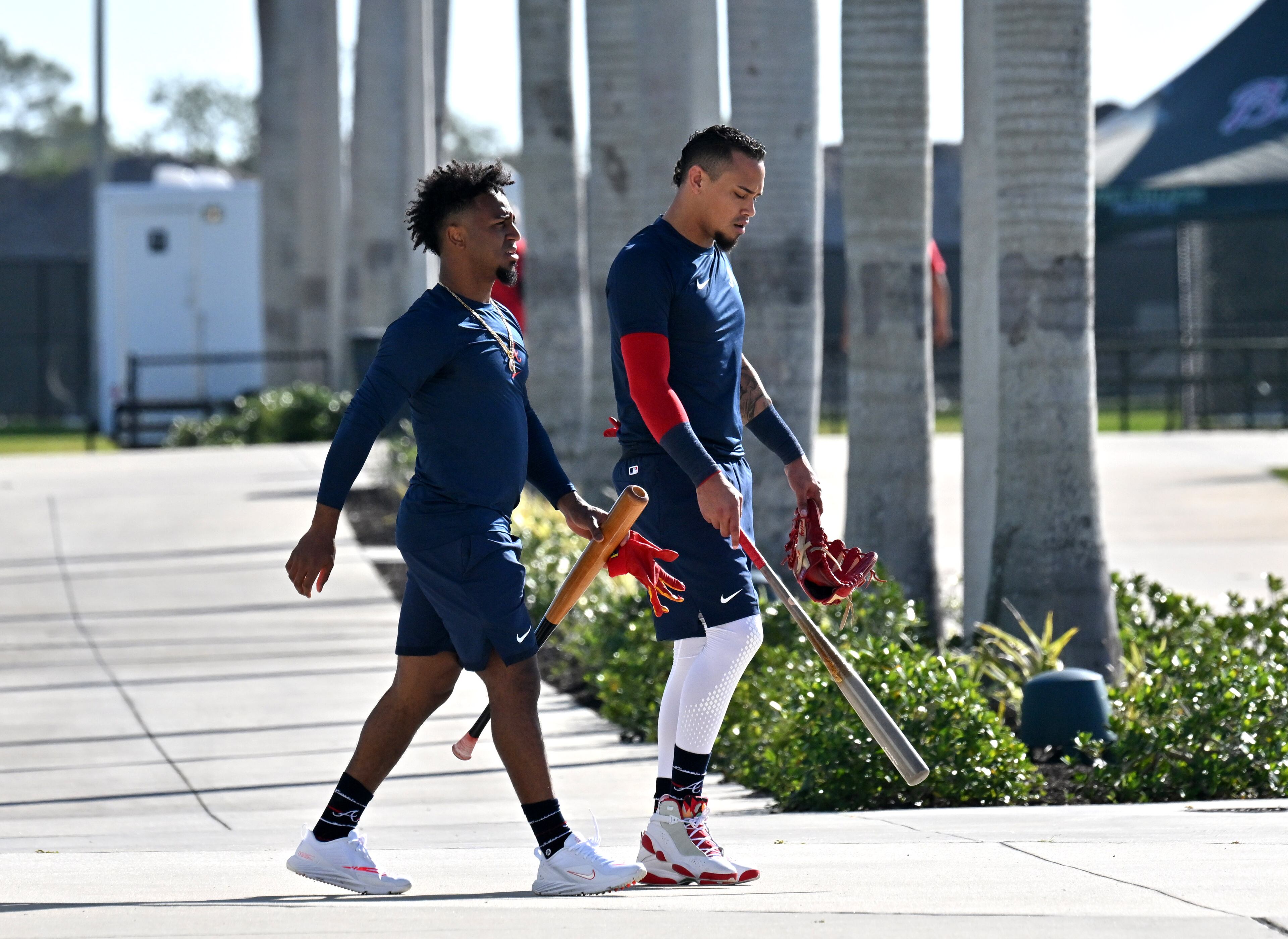 Braves second baseman Ozzie Albies (left) and infielder Orlando Arcia walk back to the clubhouse after taking batting practice during spring training Thursday at CoolToday Park in North Port, Florida. (Hyosub Shin / Hyosub.Shin@ajc.com)