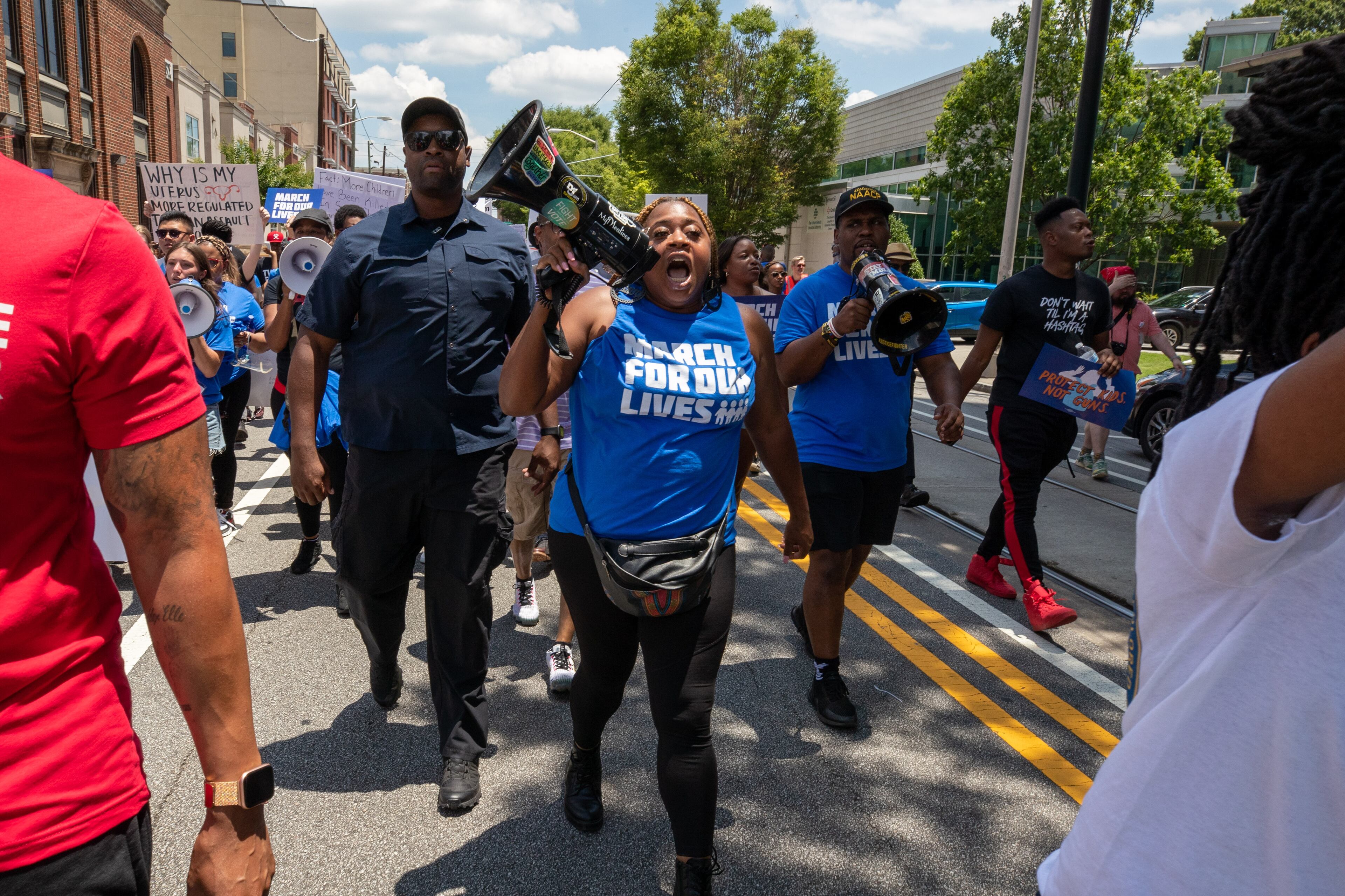 Organizer Porchse Miller leads the crowd from Ebenezer Baptist Church to Woodruff Park during the March for Our Lives rally Saturday, June 11, 2022. (Steve Schaefer / steve.schaefer@ajc.com)