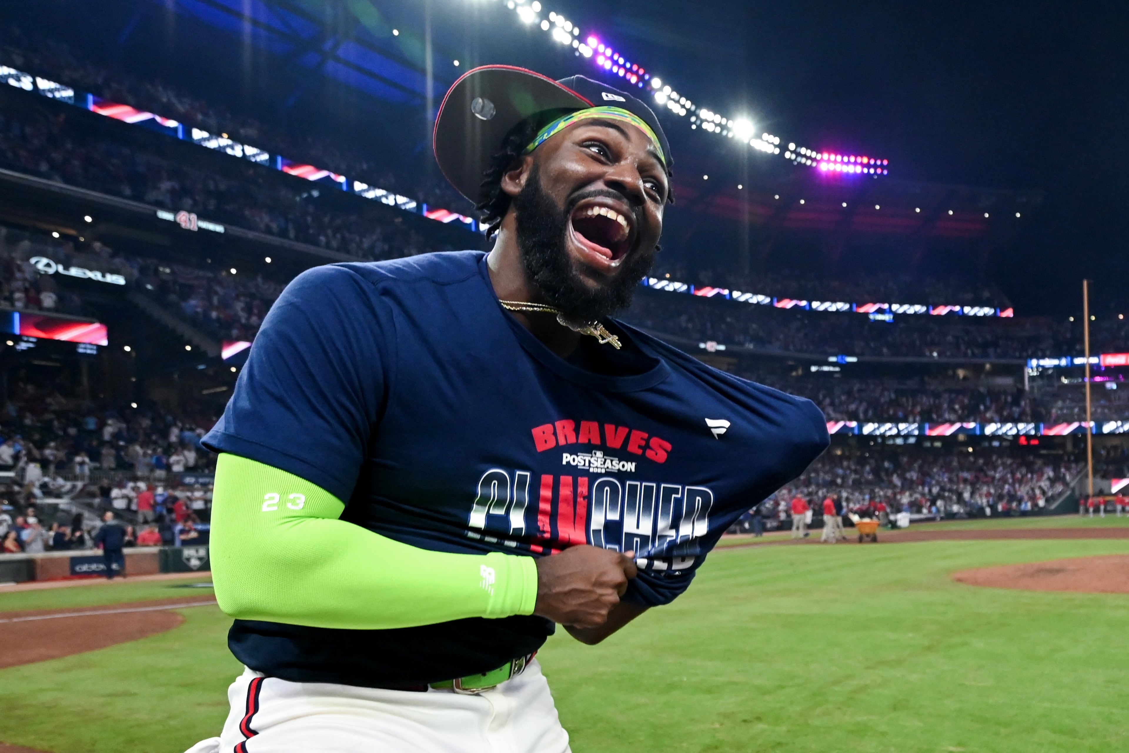 Braves center fielder Michael Harris II puts on a T-shirt as he celebrates with his team after defeating the Phillies, 6-2, to win their NL Wild Card Series on Thursday, Oct. 1, 2026, in Atlanta. (Hyosub Shin/AJC)