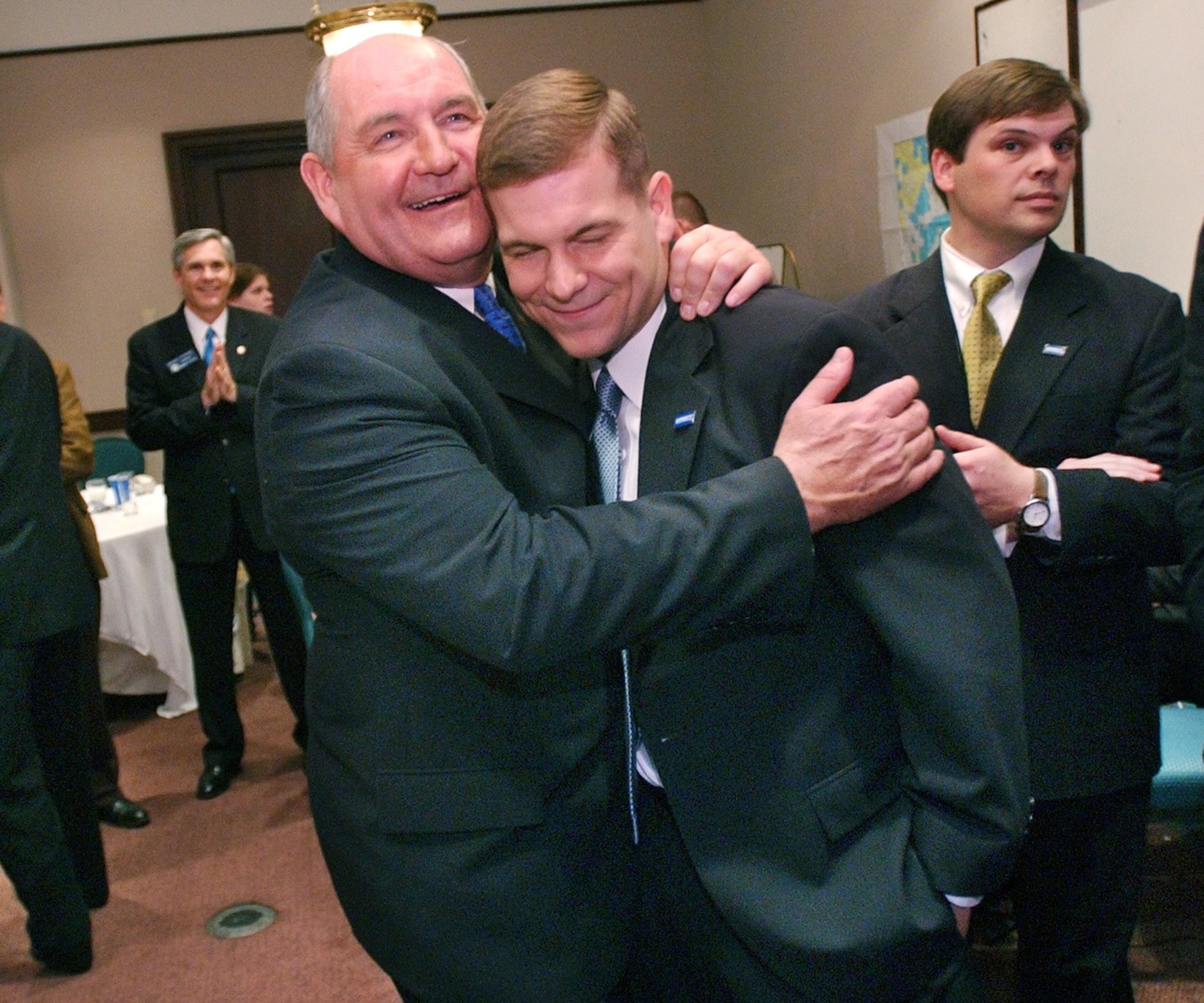 021105. ATLANTA. Sonny Perdue cq, Republican candidate for Governor, hugs his son, Jim Perdue cq, in their election night 'war room' at the Grand Hyatt Hotel in Buckhead as it became evident that Perdue would be elected the next governor. Right is Scott Rials cq, campaign manager. For story on Perdue children. RICH ADDICKS/STAFF