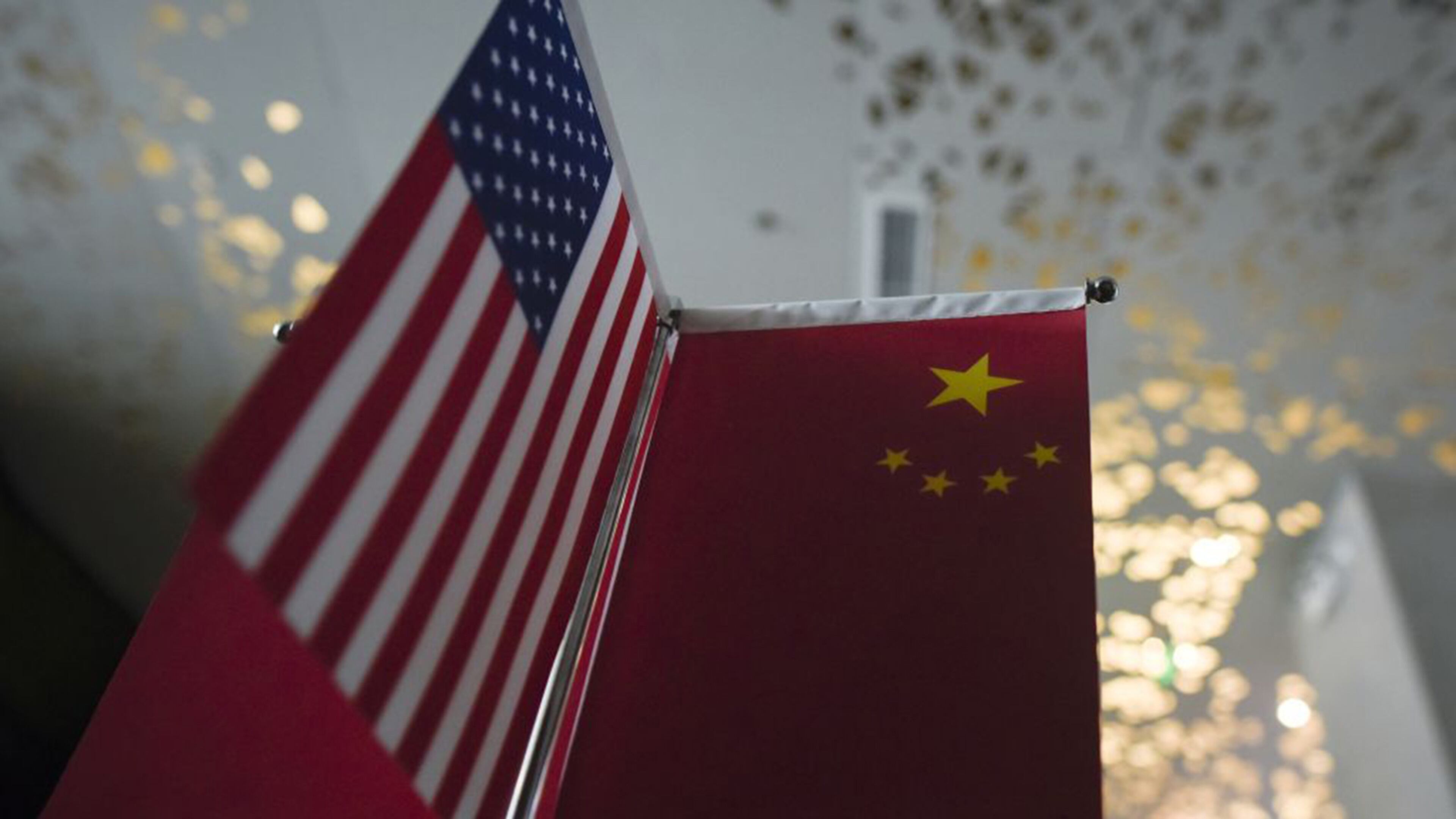 Chinese flags and American flags are displayed in a company in Beijing on Aug. 16, 2017. (Photo by WANG ZHAO/AFP via Getty Images/TNS)