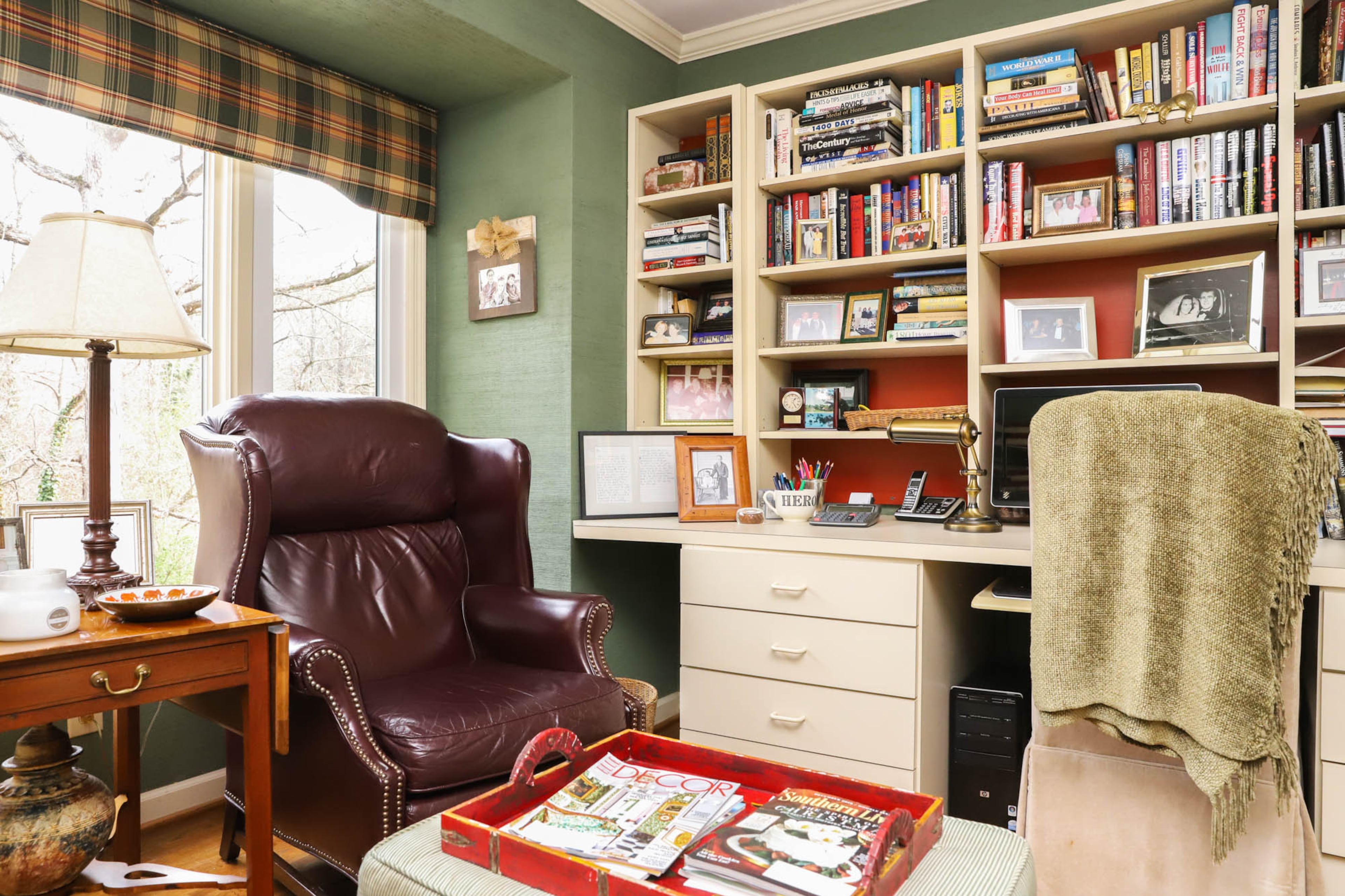 Leo Carlton built the shelves and desk in his home office. The space is cool and comfortable, with green grasscloth walls and a picture window that looks out over the backyard. Text by Shannon Dominy/Photo by Reynolds Rogers