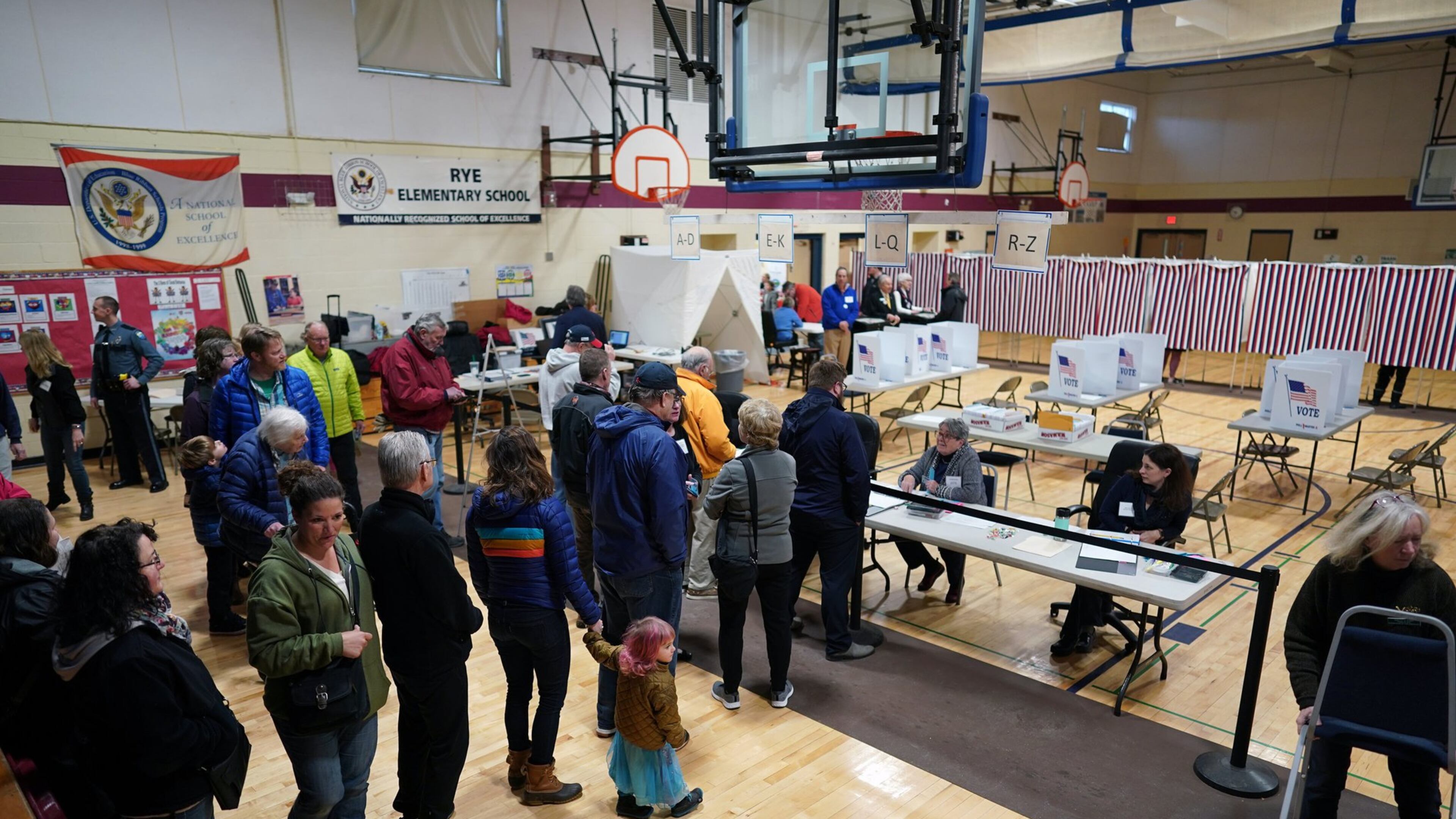 People arrive to vote at Rye Elementary School in Rye, N.H., on Tuesday. New Hampshire voters are weighing in on an unsettled Democratic presidential field in the first-in-the-nation primary. (Chang W. Lee/The New York Times)
