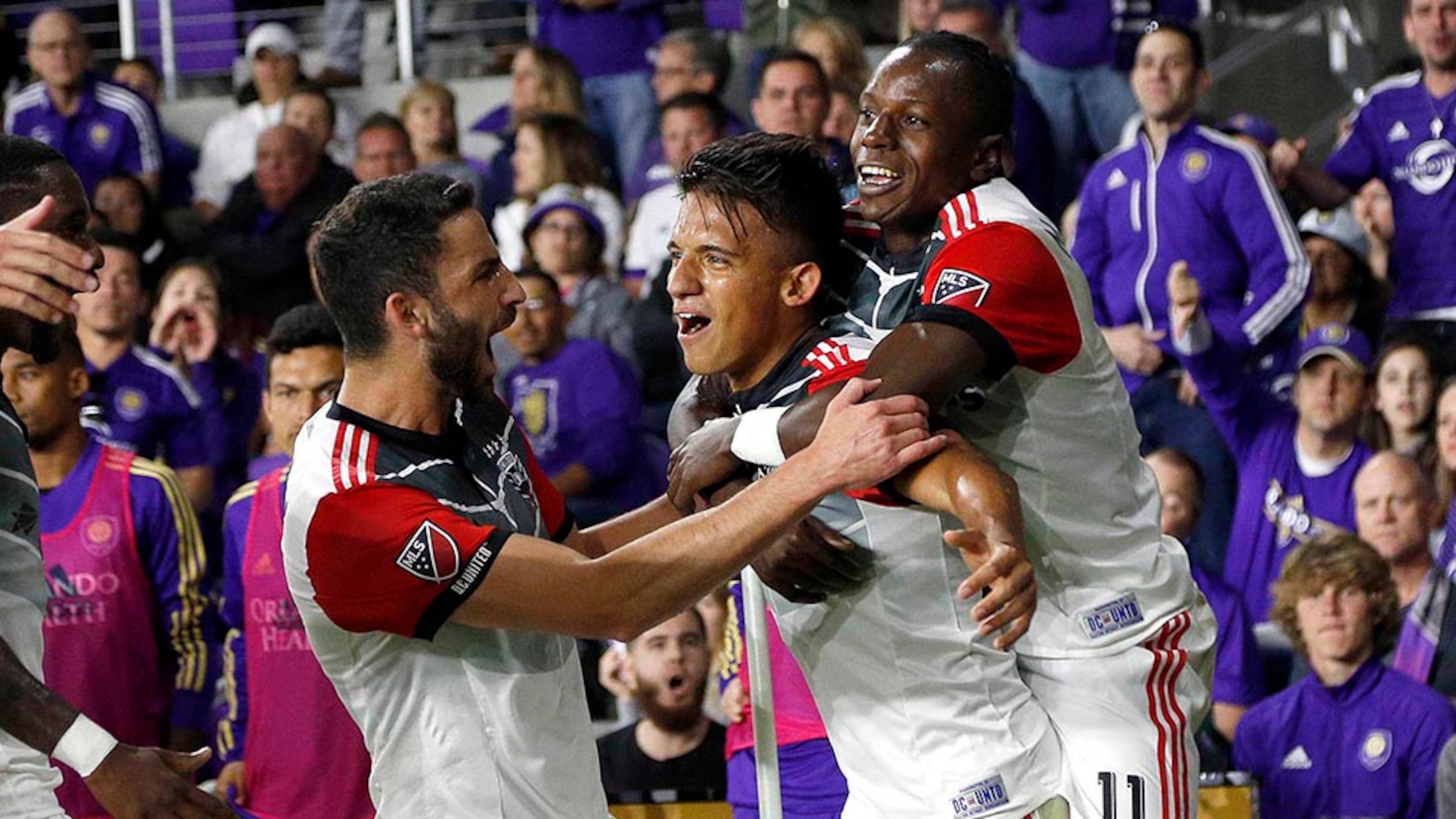 Mar 3, 2018; Orlando, FL, USA; D.C. United midfielder Yamil Asad (22) celebrates with forward Darren Mattocks (11) and teammates as he scores as goal against the Orlando City during the first half at Orlando City Stadium. Mandatory Credit: Kim Klement-USA TODAY Sports