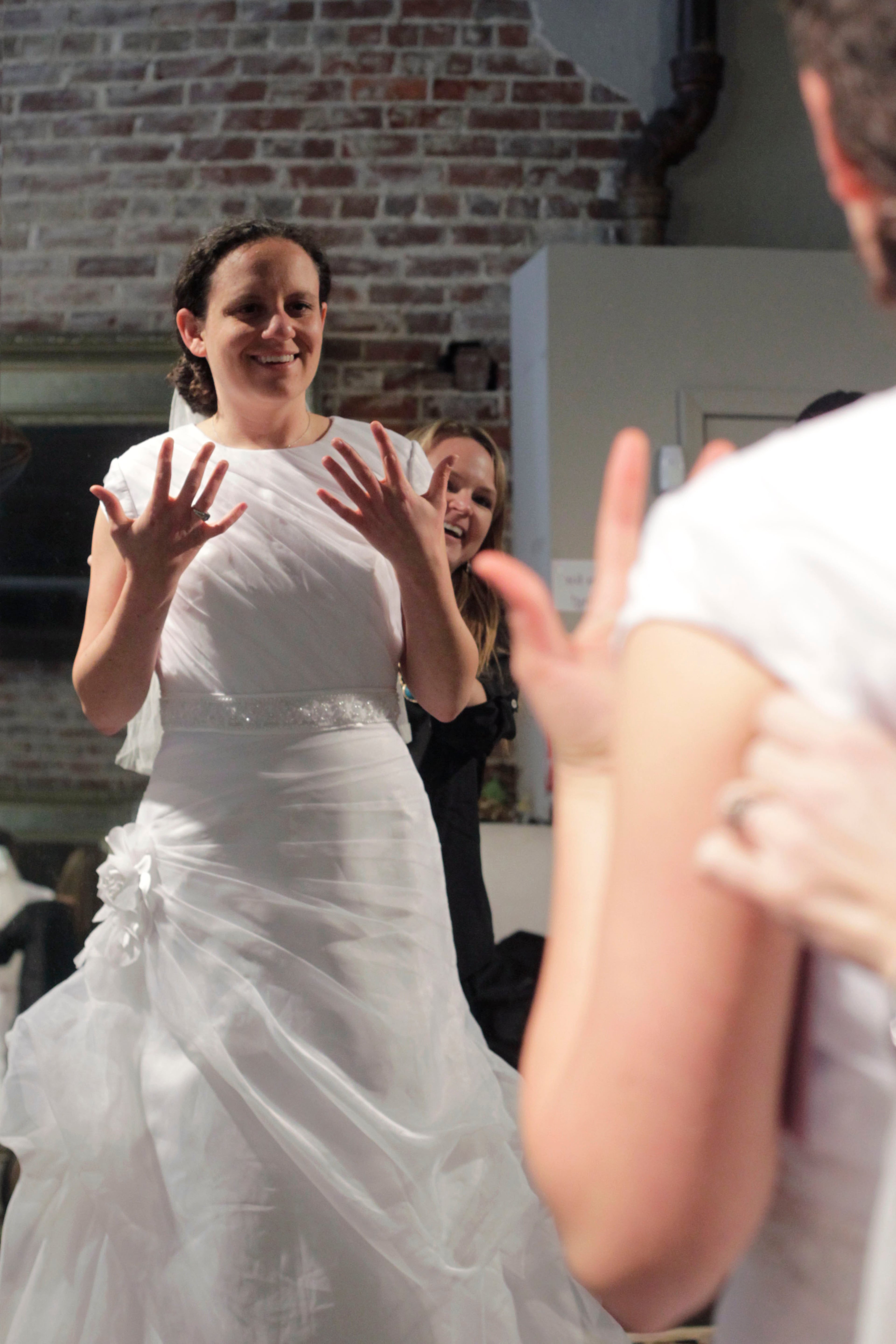 This dress with ruching, organza overlay and buttons down the back is only $99. Yvonne wants to take in the sleeves and remove the flower which could start to add up in alterations. Generally, if you’re buying an inexpensive dress, you don’t want to pay a lot for alterations.