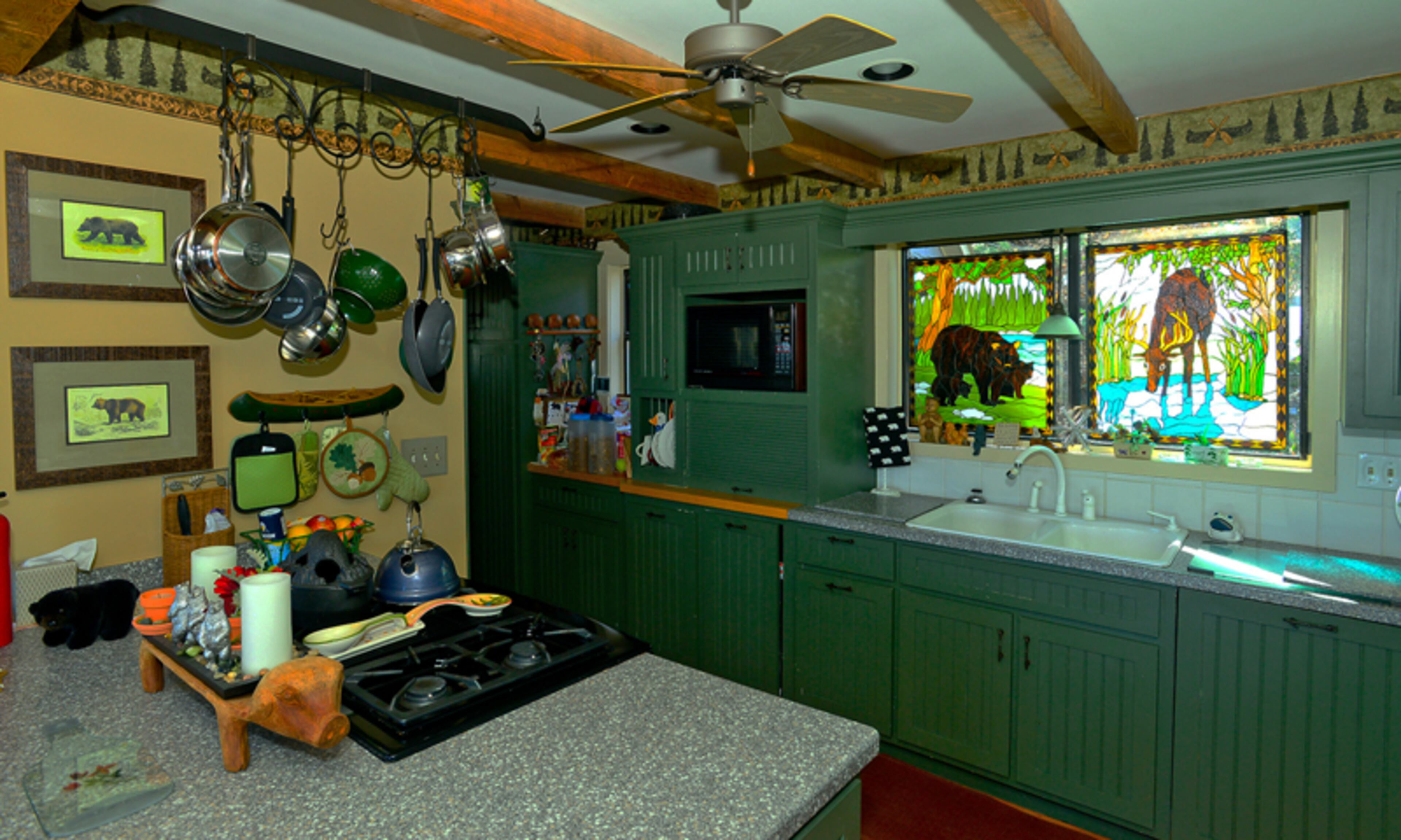 Bears fill retired news anchor John Pruitt’s home, from artwork and sculptures to stuffed animals and lamps. So many bears that they dubbed the place "Bear Pause." When homeowners John and Andrea Pruitt renovated their Big Canoe home, they put new fronts on their cabinets, added bead board to them and added beams on the ceiling.--Text by Lori Johnston