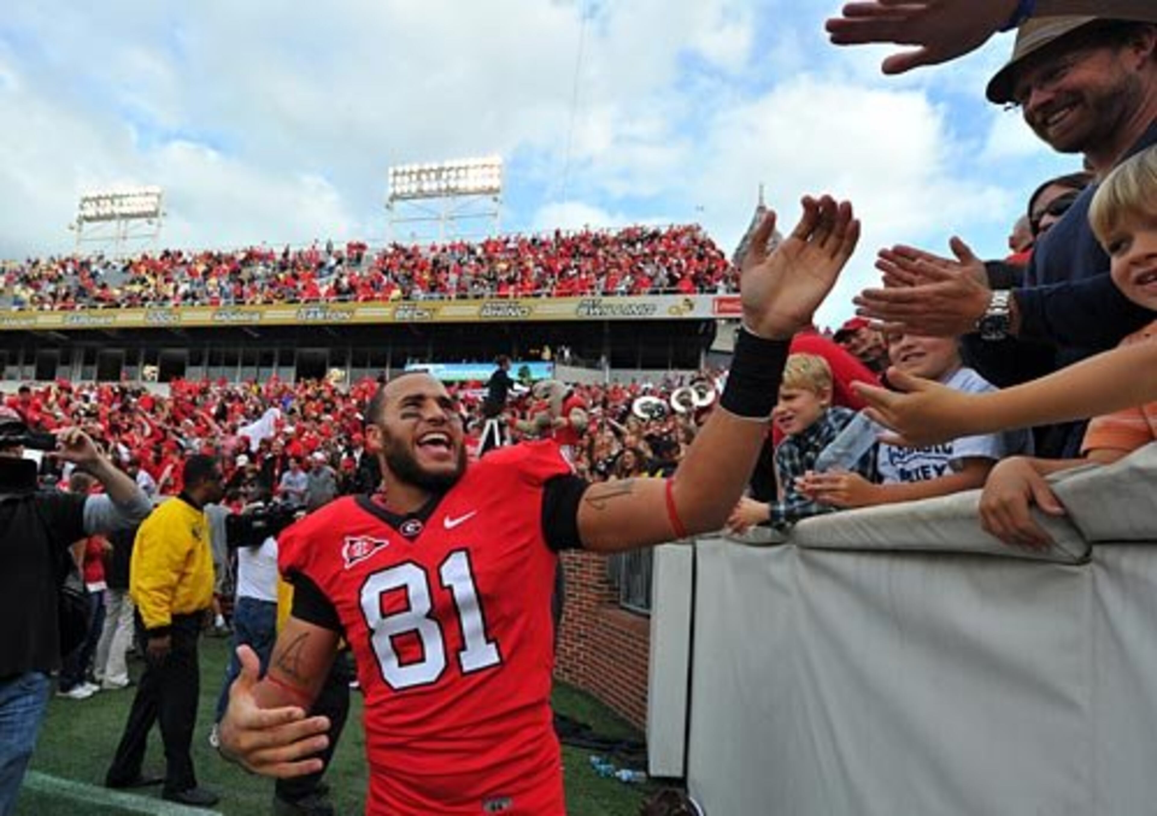 Georgia tight end Aron White celebrates with fans after the 31-17 win over Georgia Tech.