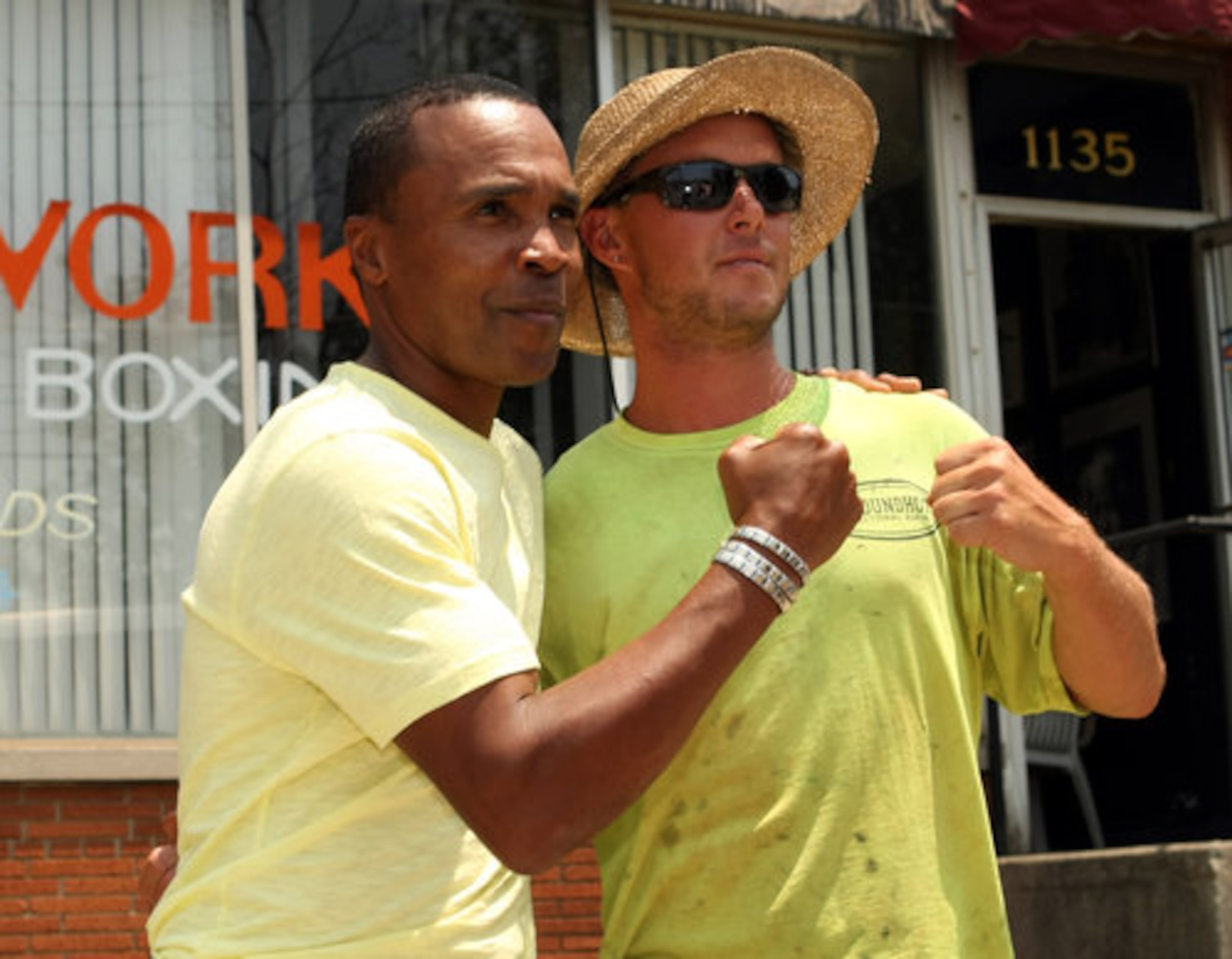 Retired professional boxer Sugar Ray Leonard gets a photograph with Groundhog Directional Boring employee Joe List out front of the Atlanta Art of Boxing on Friday afternoon in Atlanta, Ga., June 10, 2011