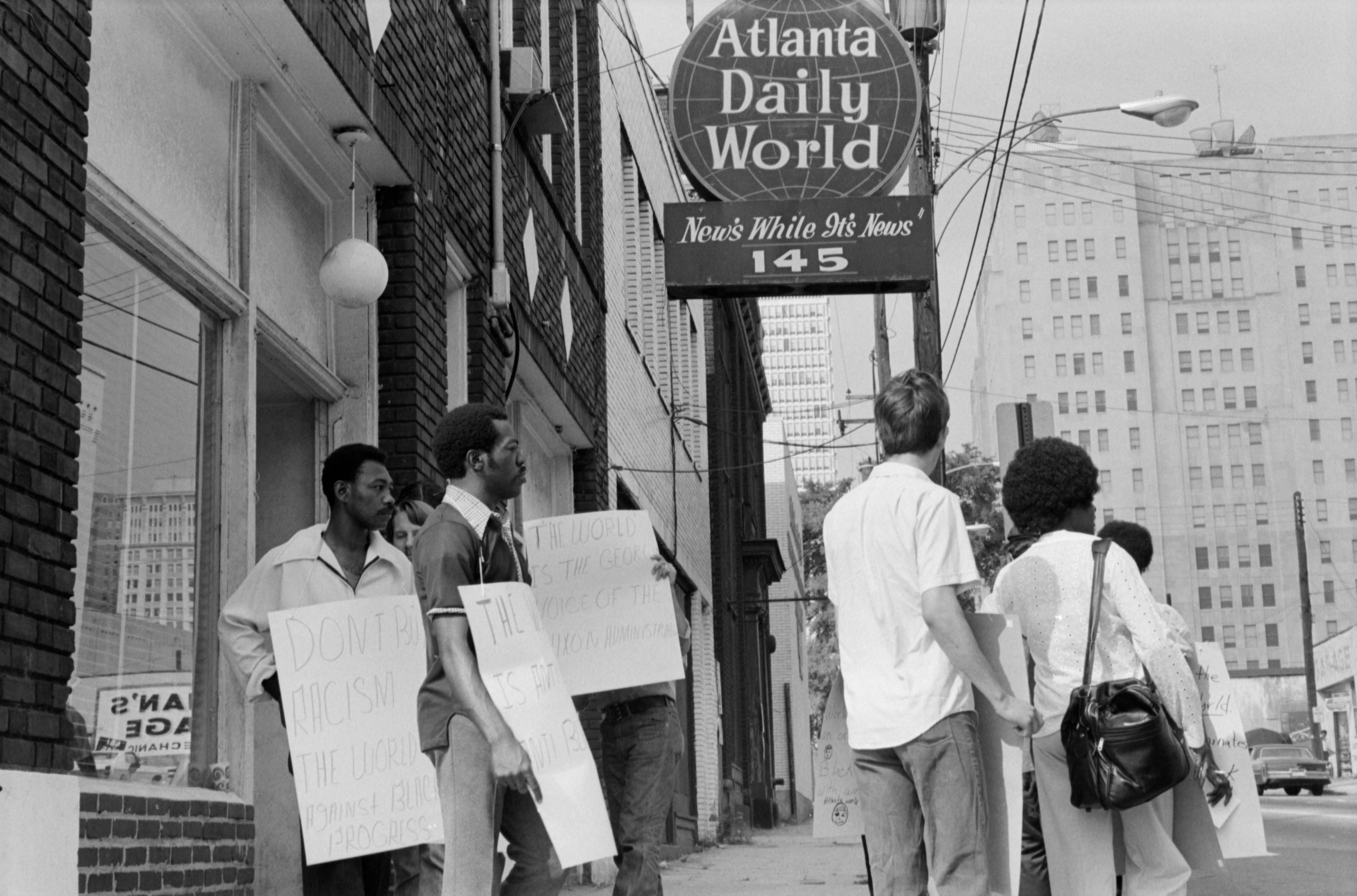 Picketers protest outside the Atlanta Daily World offices on Auburn Avenue in 1973. Founded in 1928 by William Alexander Scott II, the company at one point printed more than 40 separate newspapers at its plant on Auburn Avenue. The Daily World moved to a new location after the building was damaged by a tornado in 2008. Photo: Boyd Lewis, courtesy of Kenan Research Center at the Atlanta History Center.