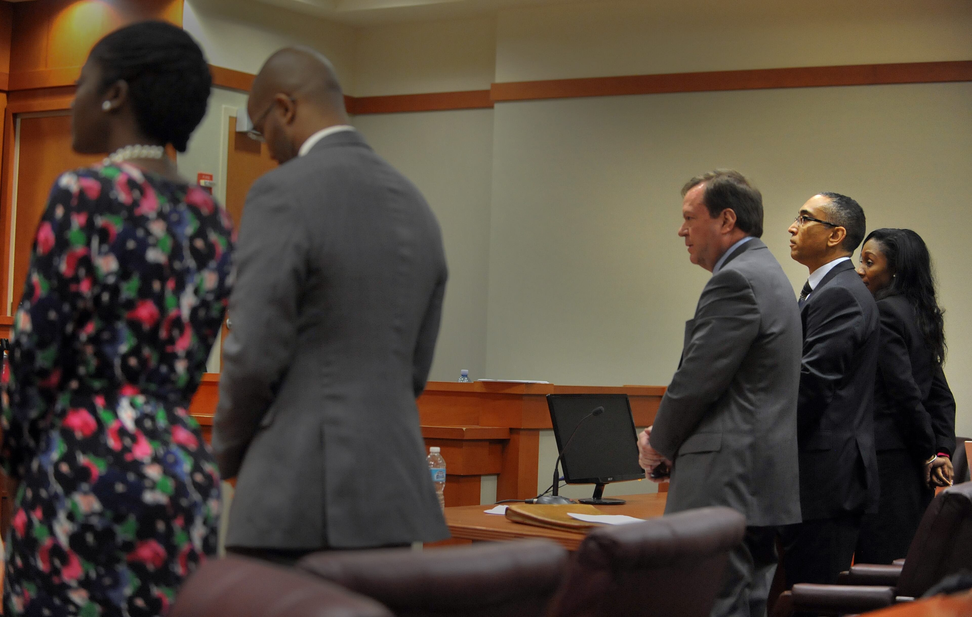 Attorneys stand as the jury enters the courtroom before rendering their verdict. DeKalb CEO Burrell Ellis was found guilty on 4 counts in his retrial before Superior Court Judge Courtney Johnson Wednesday, July 1, 2015.