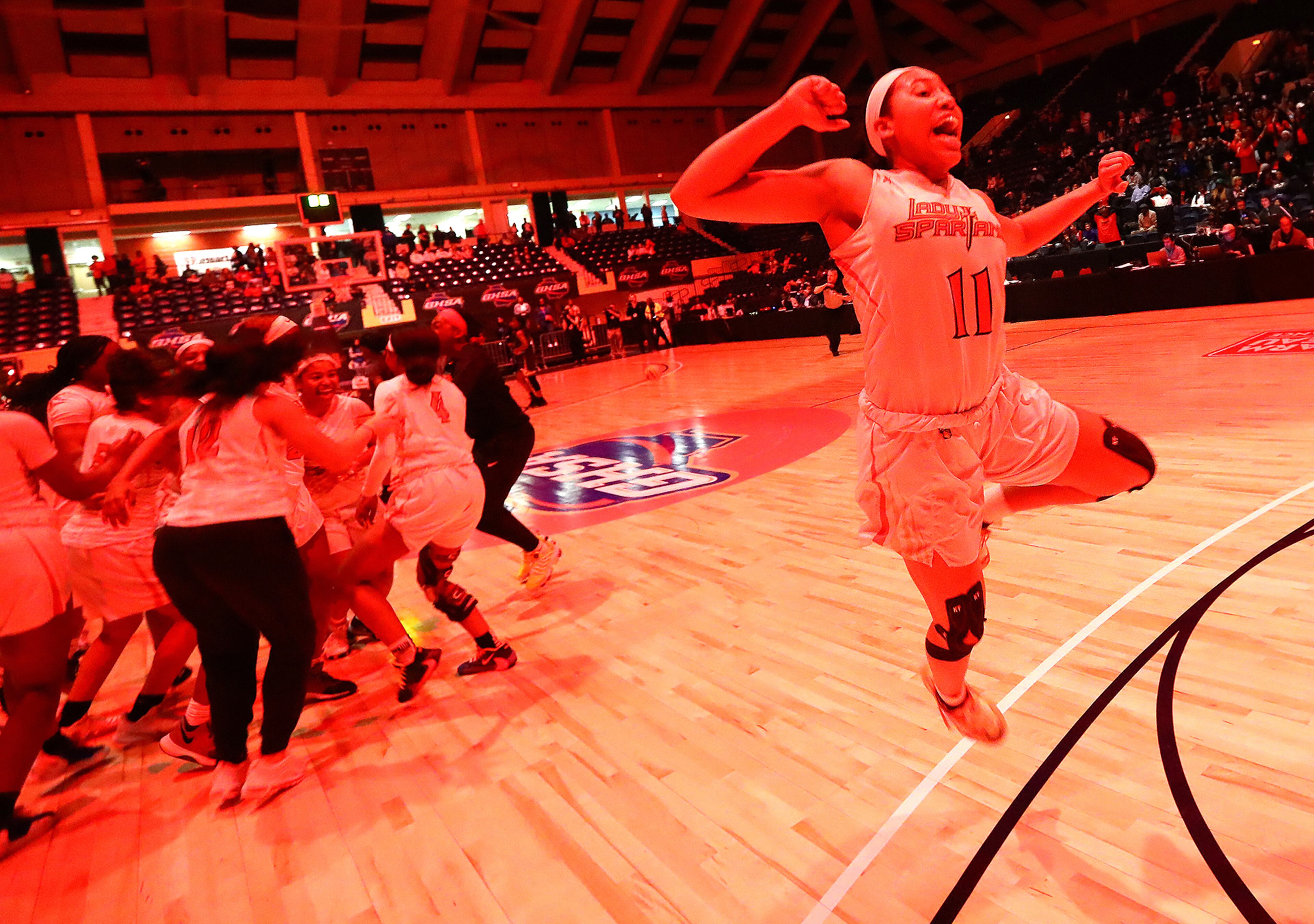 VICTORY LEAP || March 5, 2020, Macon: Greater Atlanta Christian star Ava Irvin leaps in the air as the lights turn red when time expires in a victory over Beach 54-44 to win the Class AAA girls state basketball championship. (Curtis Compton ccompton@ajc.com)
