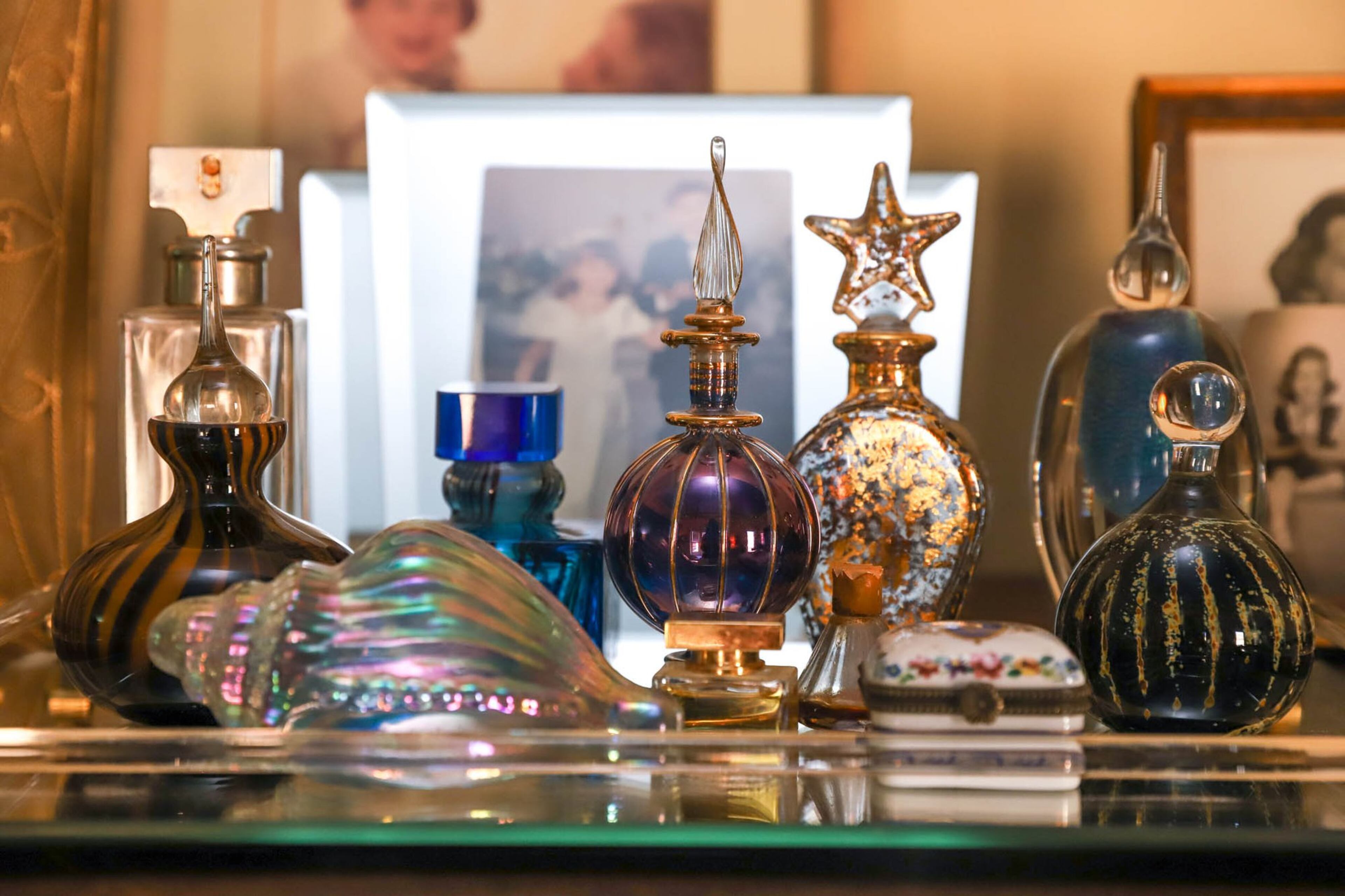 In Marcia Jaffe’s master bedroom she displays her collection of glass perfume bottles, some of which were her mother’s and some of which Jaffe has collected in her travels to cities like Prague, Vienna and Venice. Text by Shannon Dominy. Photo by Reynolds Rogers.