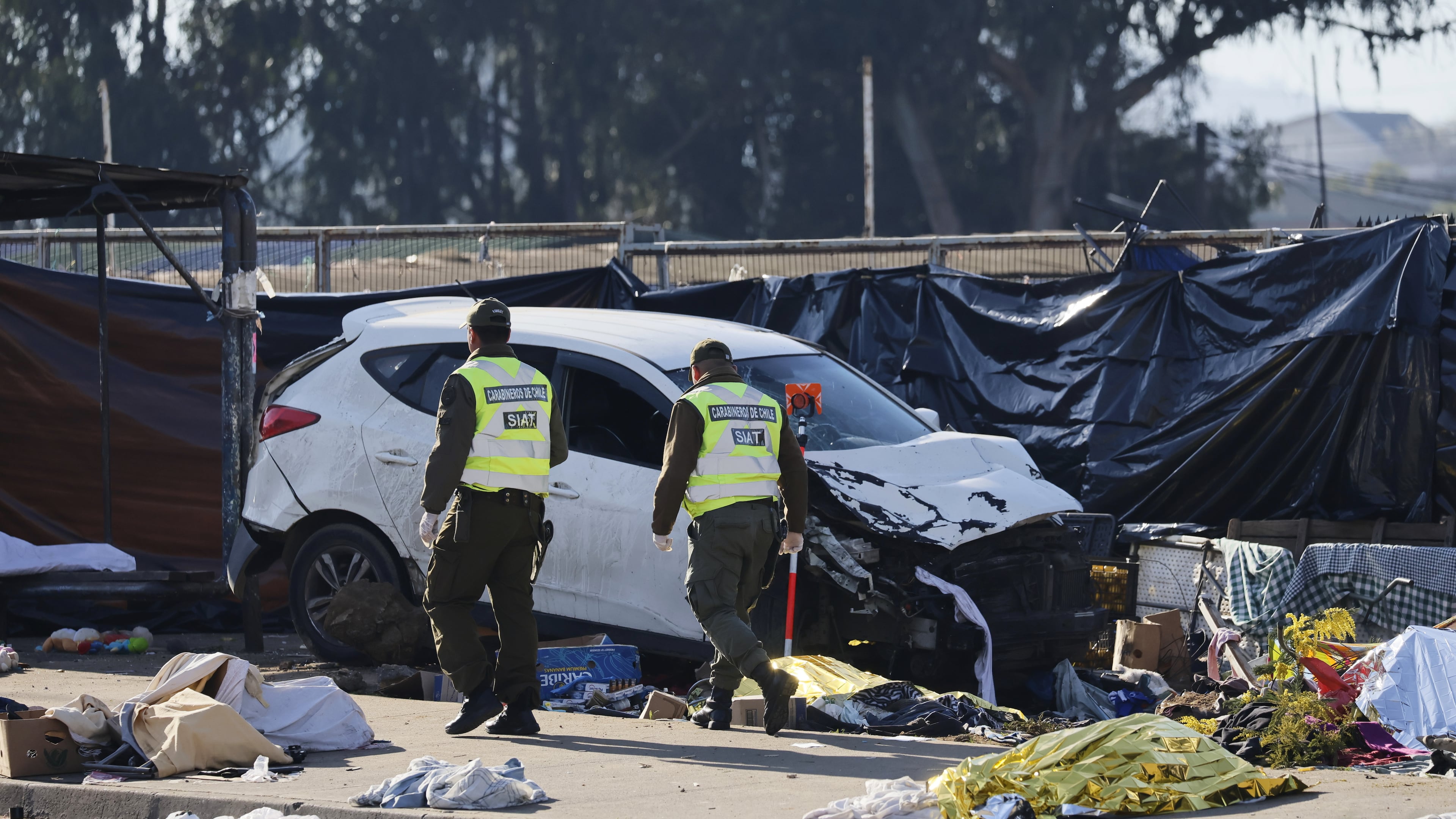 Police inspect a car after it struck a crowd at an open-air market in Vina del Mar, Chile, Sunday, July 12, 2026. (Sebastian Cisterna/ATON via AP)