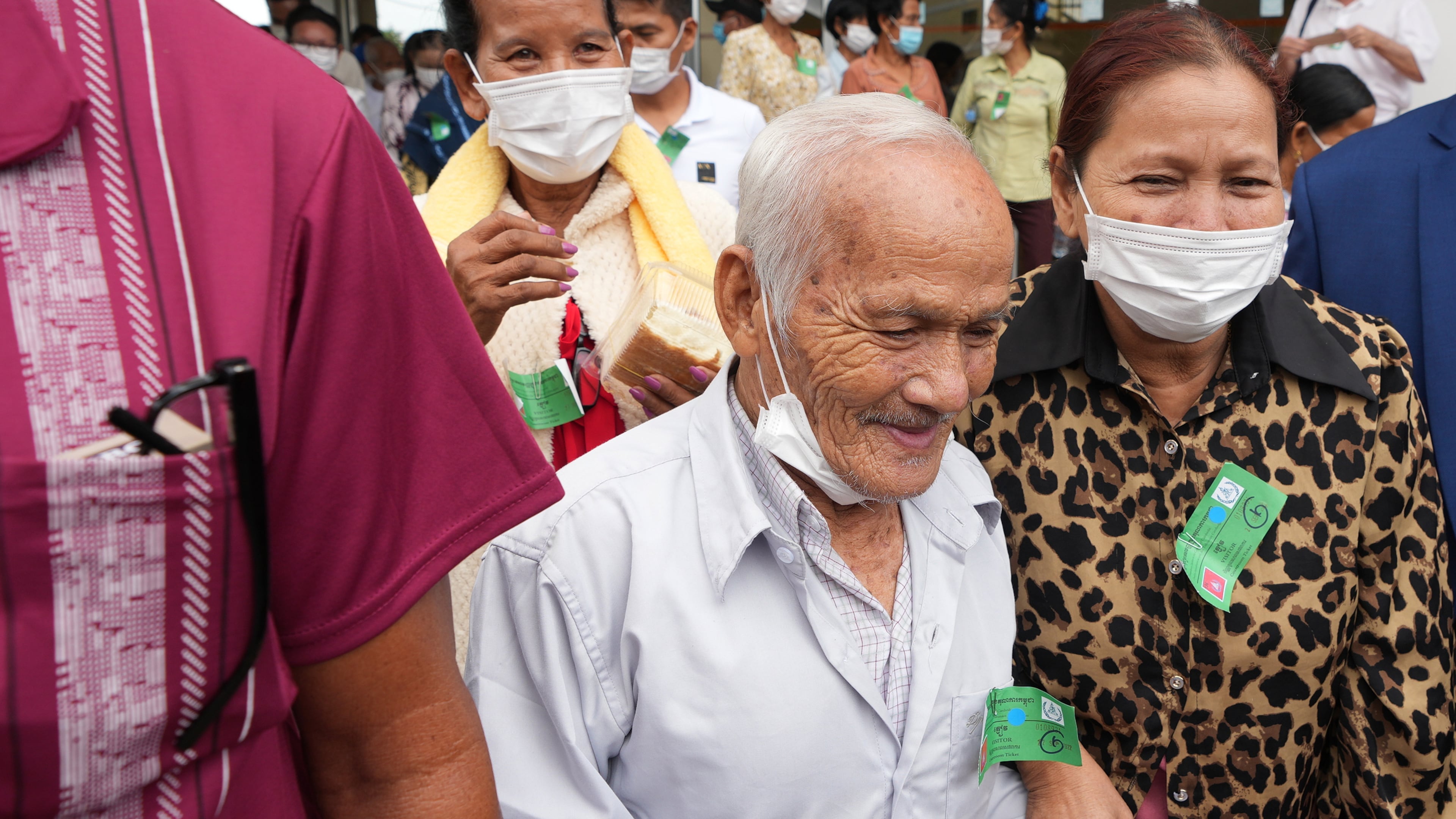 FILE- Bou Meng, center, former S-21 prison survivor, leaves the courtroom after the verdict is announced for Khieu Samphan, former Khmer Rouge head of state, at the U.N.-backed war crimes tribunal in Phnom Penh, Cambodia, Thursday, Sept. 22, 2022. (AP Photo/Heng Sinith, file)