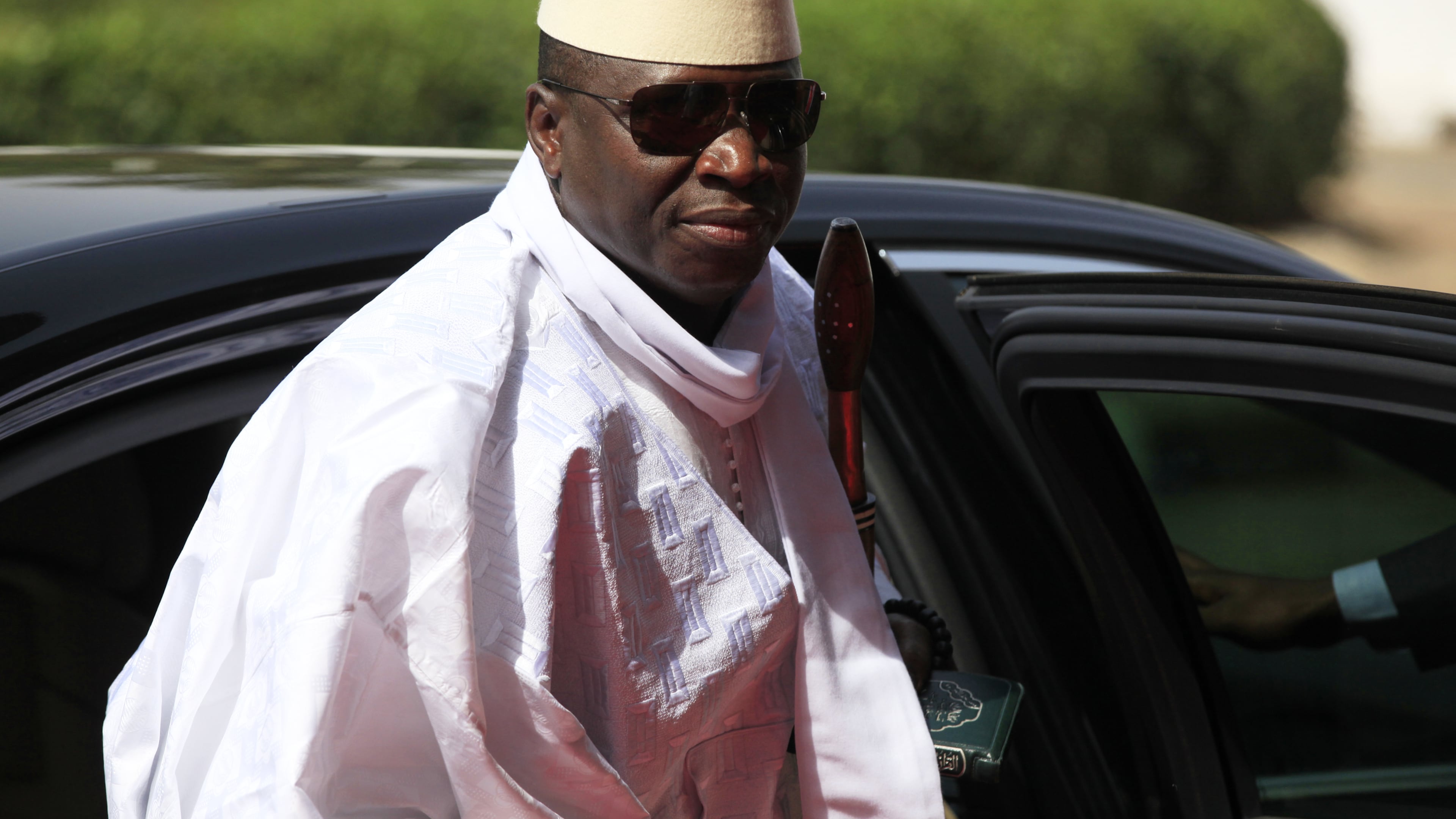 FILE - Gambia's President Yahya Jammeh arrives for a summit to address a seminar on security in Abuja, Nigeria, on Feb. 27, 2014. (AP Photo/Sunday Alamba, File)